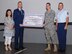 KUNSAN AIR BASE, Republic of Korea -- Senior Airman Jason Devore, 8th LRS vehicle management, receives a check for $1,875 here Aug. 30 for implementing a new process to save the Air Force money and increase the mission-capable rates for all vehicles on base. (U.S. Air Force photo/Senior Airman Benjamin Stratton)