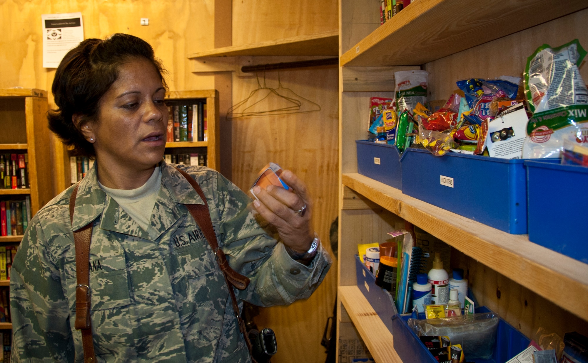 Master Sgt. Michelle Ana, 451st Expeditionary Logistics Readiness Squadron, checks out the items that can be found at the Airman's Attic at the Camp Samek recreation center Aug. 27, 2011. Volunteers will restock the attic's shelves with the donated items every Monday. (U.S. Air Force photo by Senior Airman David Carbajal)