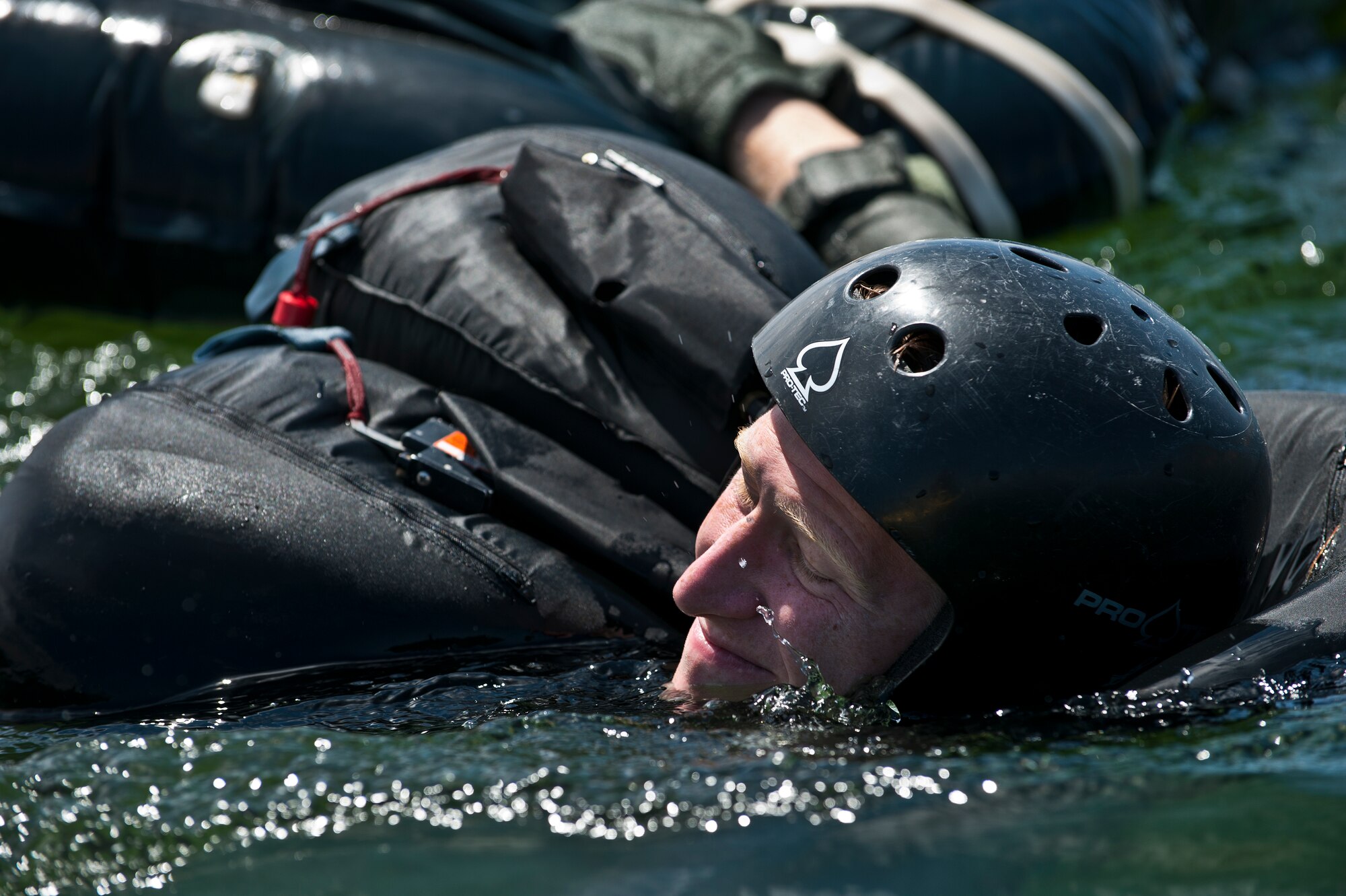 U.S. Air Force Capt. Justin Elliot, 422nd Test and Evaluation Squadron, F-15E Strike Division pilot, Nellis Air Force Base, Nev., pulls his raft while exiting the lake during the Survival, Evasion, Resistance and Escape water survival training course Aug. 17, 2011, at Lake Mead, Nev. SERE specialists train high risk aircrew and personnel to survive, evade, and return safely should they eject, bailout, or otherwise become isolated during combat, anywhere in the world. (U.S. Air Force photo by Airman 1st Class George Goslin/Released)
