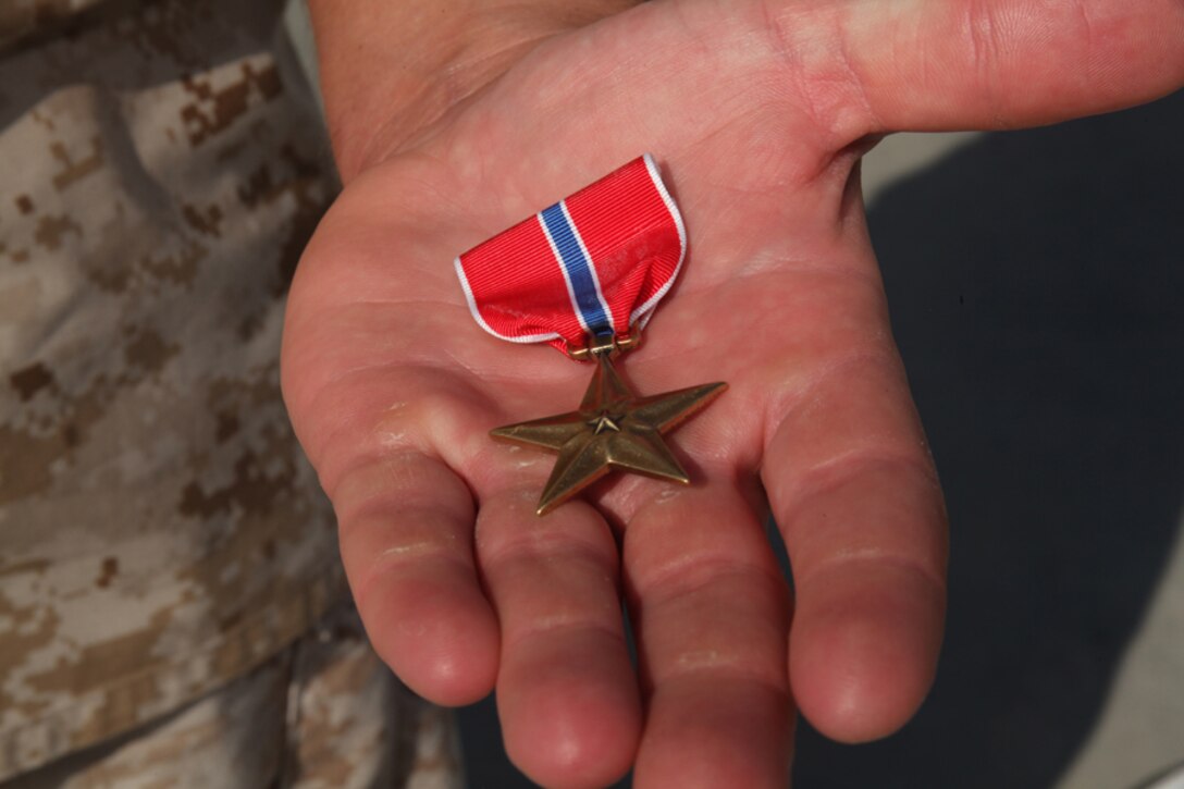 Sergeant Ryan M. Krochmolny, machine gun section leader, Kilo Company, 3rd Battalion, 5th Marine Regiment, 1st Marine Division, is awarded the Bronze Star with Combat “V” Sept. 1, 2011, for heroic actions while deployed to Sangin, Afghanistan.  Krochmolny was a machine gun section leader and exhibited great leadership, courage and unselfishness during the seven-month deployment.  In one instance, he carried a wounded Marine several hundred yards and shielded the Marine from enemy machine-gun fire.  (Official Marine Corps photo by Lance Cpl. Timothy J. Lenzo)
