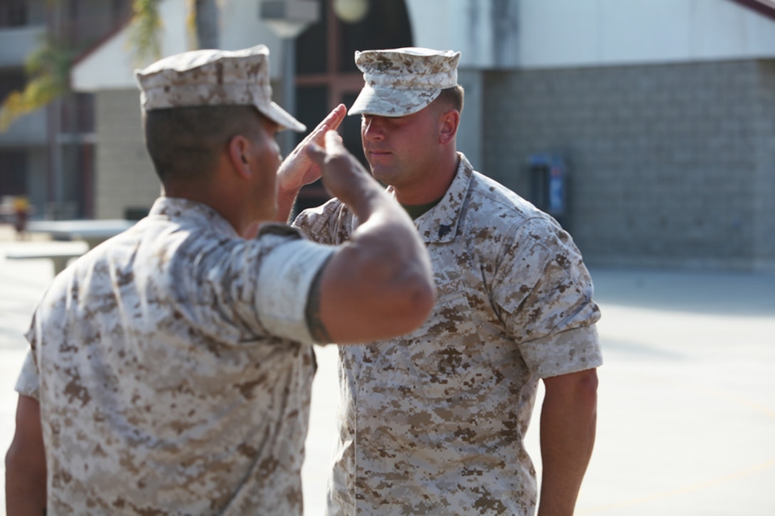 Sergeant Ryan M. Krochmolny, machine gun section leader, Kilo Company, 3rd Battalion, 5th Marine Regiment, 1st Marine Division, salutes 1st Lt. Victor M. Garcia, Kilo Company’s executive officer, during his award ceremony, Sept. 1, 2011, for the Bronze Star with Combat “V” he earned while serving under Garcia in Sangin, Afghanistan.  Krochmolny took control of his platoon when an improvised explosive device blew up resulting in multiple casualties.  Krochmolny’s quick thinking and decisiveness under pressure helped him lead his Marines through dire circumstances during his deployment. (Official Marine Corps photo by Lance Cpl. Timothy J. Lenzo)