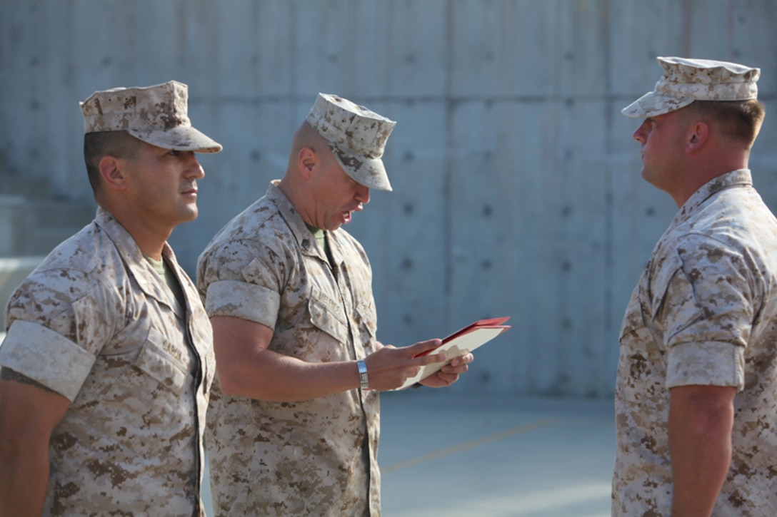 Sergeant Ryan M. Krochmolny, machine gun section leader, Kilo Company, 3rd Battalion, 5th Marine Regiment, 1st Marine Division, stands at attention as his citation for his Bronze Star with Combat “V” Sept. 1, 2011.  Krochmolny said he takes the responsibility of being a leader of Marines seriously and feels he is responsible for bringing them home safely.  Krochmolny led his Marines to help others who had been pinned down by enemy gun fire. (Official Marine Corps photo by Lance Cpl. Timothy J. Lenzo)