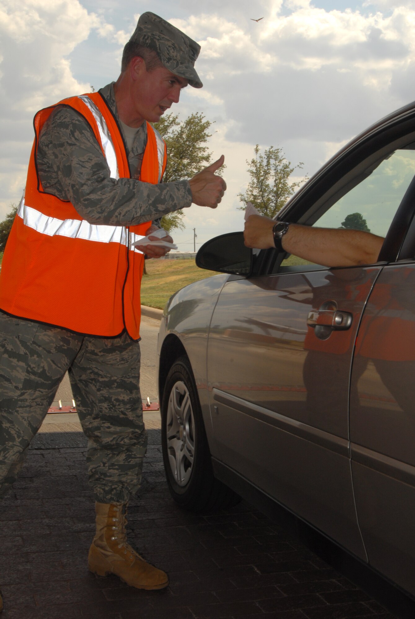 GOODFELLOW AIR FORCE BASE, Texas --  Col. JD Willis, 17th Training Group Commander, wishes base members a fun and safe Labor Day weekend. Commanders, First Sergeants, Chiefs, and Green Knights Chapter 64 Motorcycle Group handed out safety cards at the gates to ensure members keep their focus on safety and risk management during the extended three-day weekend. (U.S. Air Force photo/Senior Airman Tong Duong)