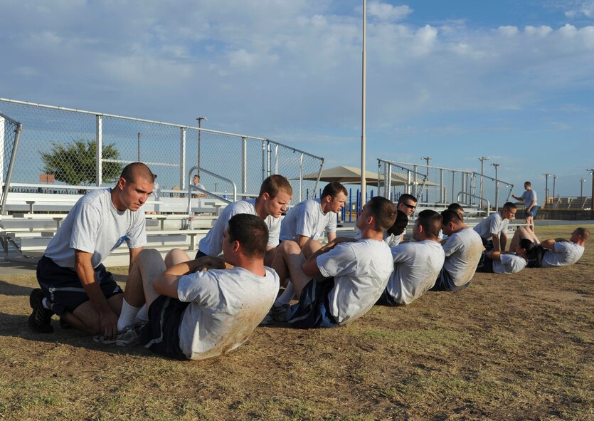 First Term Airman Center Airmen perform the sit-up portion of a mock physical training test Aug. 24 at Luke Air Force Base.  The mock PT test is done to gauge fitness levels and inform supervisors of areas in need of improvement.  (U.S. Air Force photo by Senior Airman Darlene Seltmann)