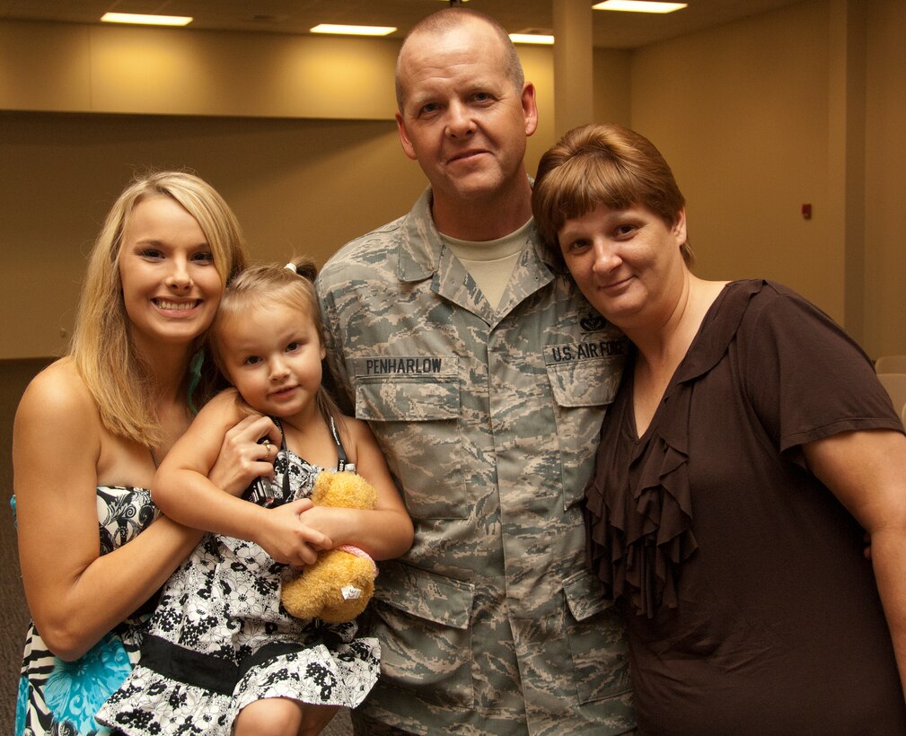A dozen 403rd Wing civil engineers returning from a six-month deployment were reunited with their families at a reception in the Roberts Consolidated Maintenance Facility Sept. 1. Senior Airman Terry Penharlow was welcomed by (from left to right) daughter Brandy, granddaughter McKenzie and his wife, Beverly.  (U.S. Air Force photo by Master Sgt. Michael Duhe)