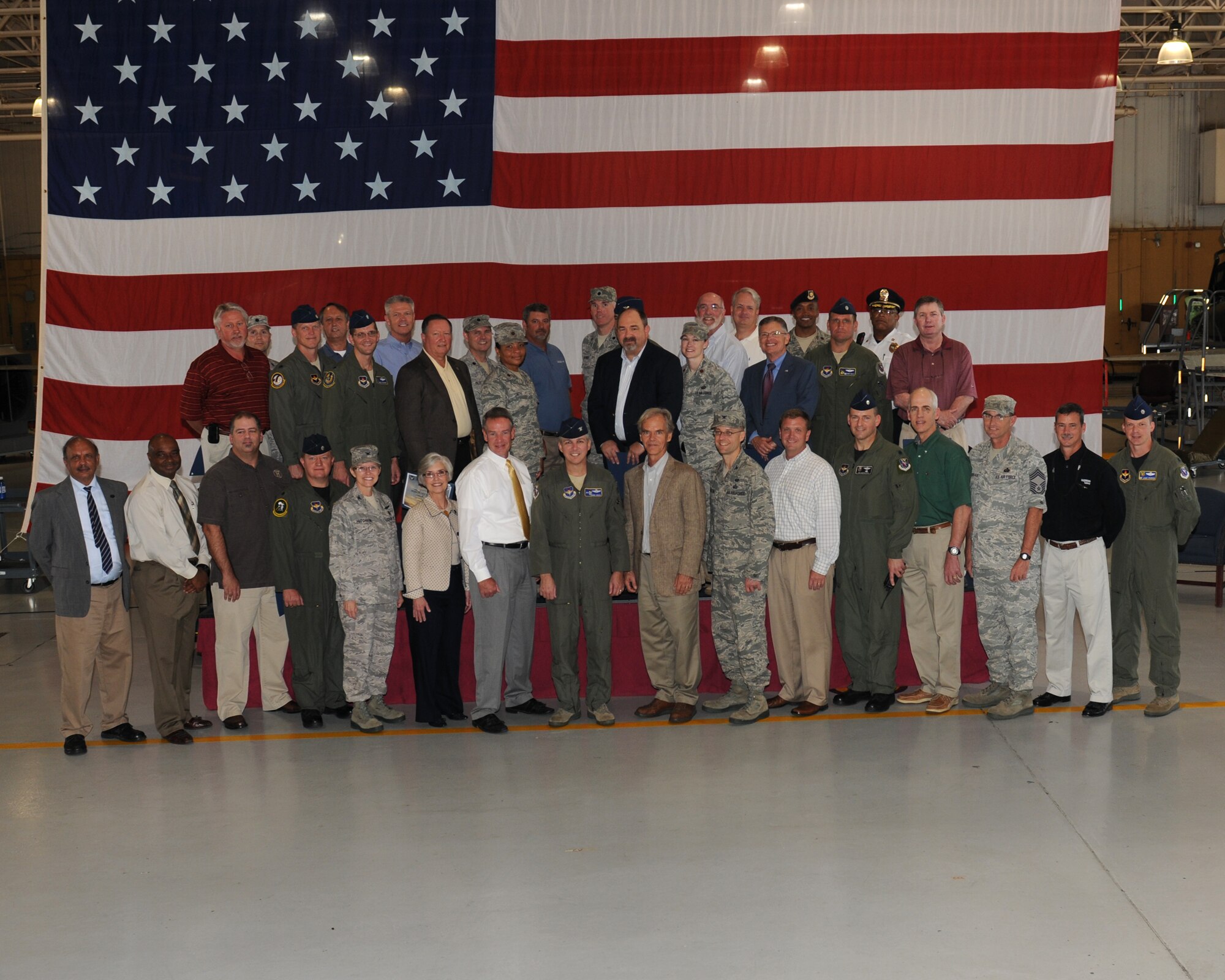 The newly inducted honorary commanders pose with their wing, group, and squadron commanders after the first honorary commander induction ceremony held on Aug. 30 at the BLAZE Hanger. The Honorary Commander program is a community relations program that gives selected community leaders an opportunity to gain a deeper and more personal insight into the Air Force and the mission of Columbus AFB.  (U.S. Air Force photo/Melissa Doublin)
