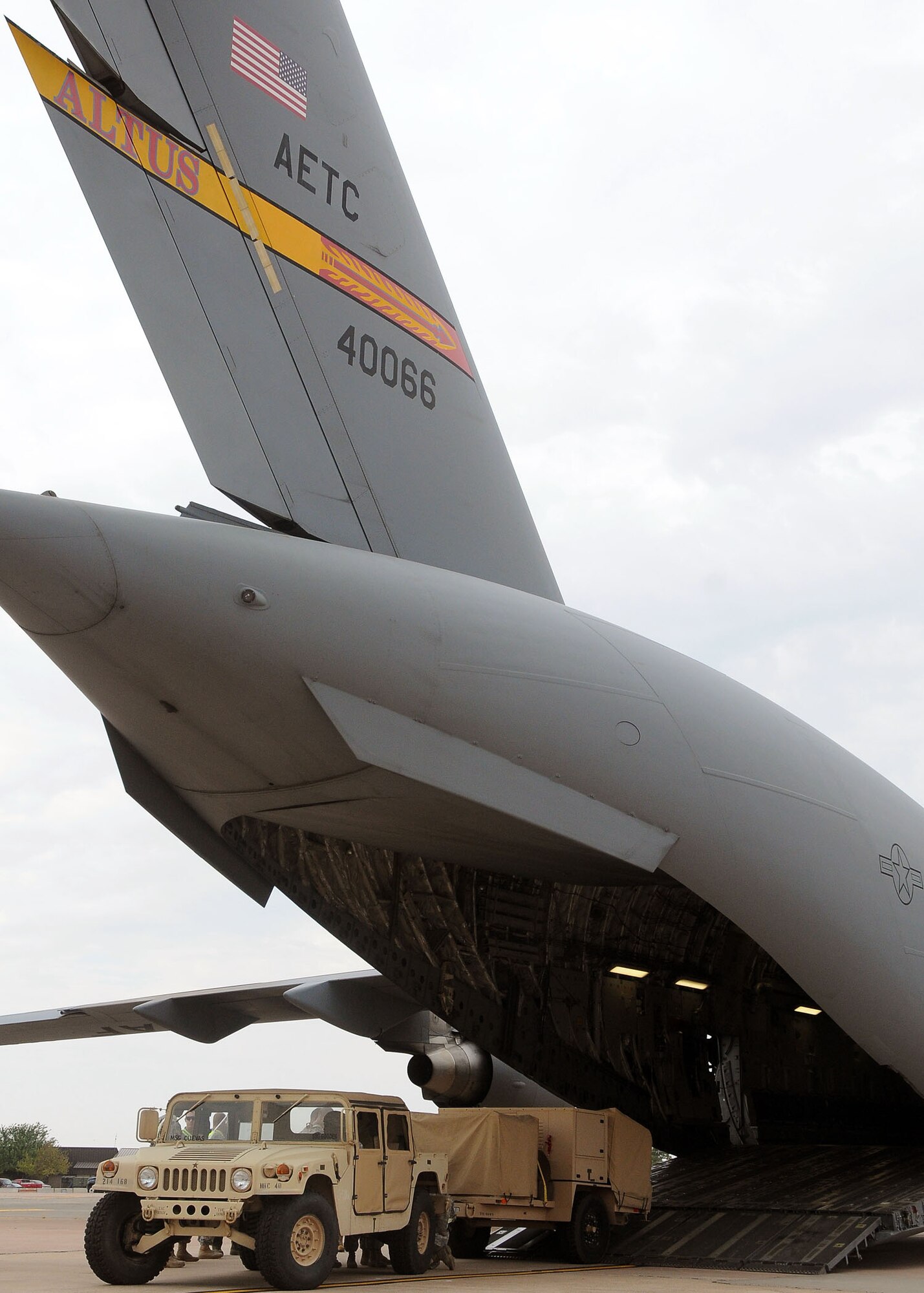 ALTUS AIR FORCE BASE, Okla. – Soldiers from the 168th Brigade Support Battalion, Fort Sill, Okla., and a loadmaster from the 58th Airlift Squadron practice humanitarian relief preparation Aug. 30, 2011. The joint team of about 50 loaded 12 vehicles and six trailers of equipment on and off a C-17 Globemaster III. The goal of this exercise was to train and equip involved units to support the safety, security and survival needs of an area as a result of a natural disaster.  (U.S. Air Force photo by Staff Sgt. Marianne E. Lane/ 97th Air Mobility Wing Public Affairs-Released) 