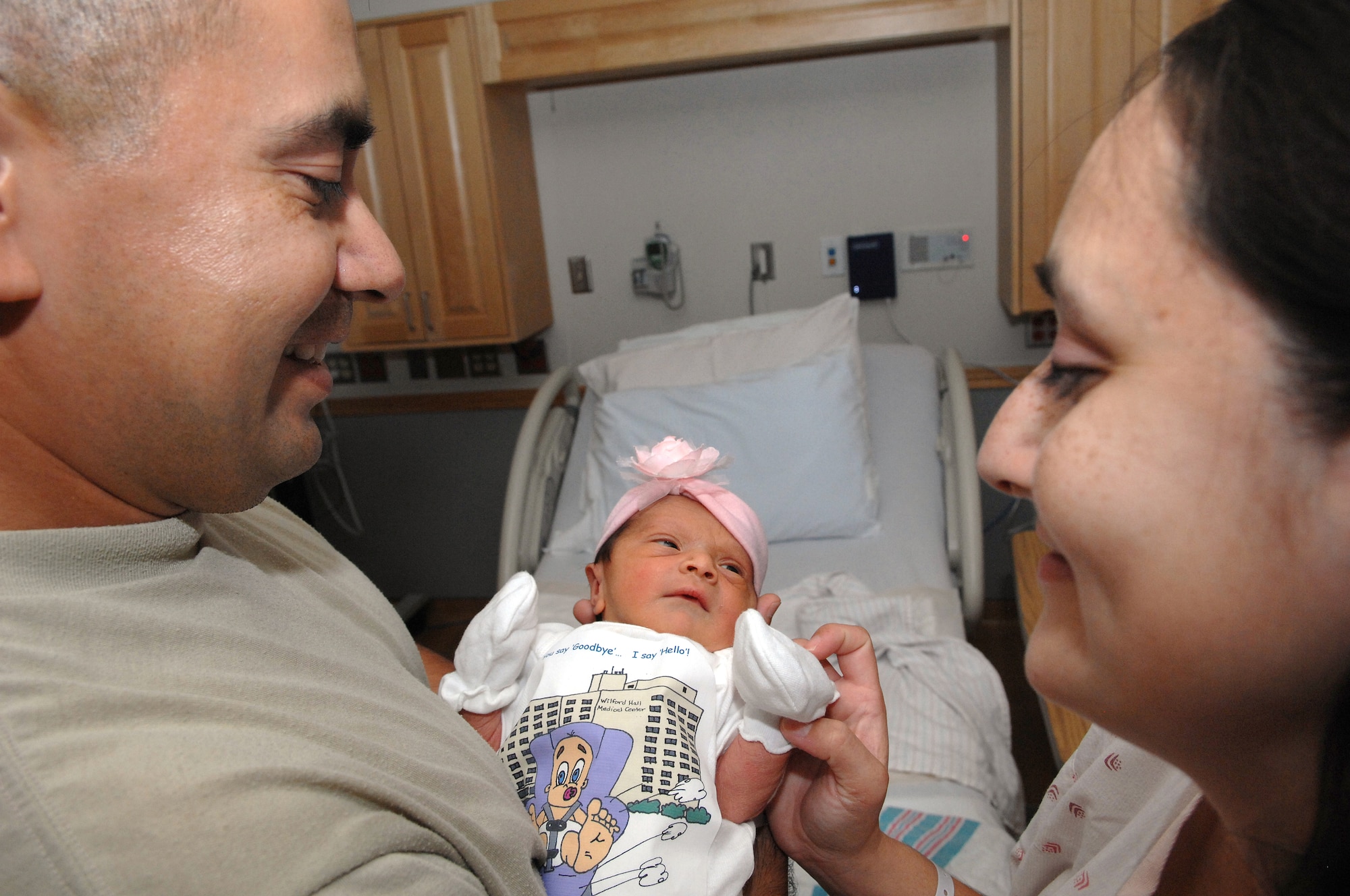 Proud parents Army Staff Sgt. Mario Perez and wife Dina were surprised to hear their new infant, Laurel Perez, was the last baby to be born at Wilford Hall Medical Center, Lackland Air Force Base, Texas on Aug. 28, 2011. The Hauth Birthing Center, known for its worldwide tertiary referral center and premier tri-service teaching facility, is relocating across town to Fort Sam Houston to a state-of-the art facility. The move will establish an integrated medical team of top-notch Air Force and Army staff. (U.S. Air Force photo/Staff Sgt. Robert Barnett) 
