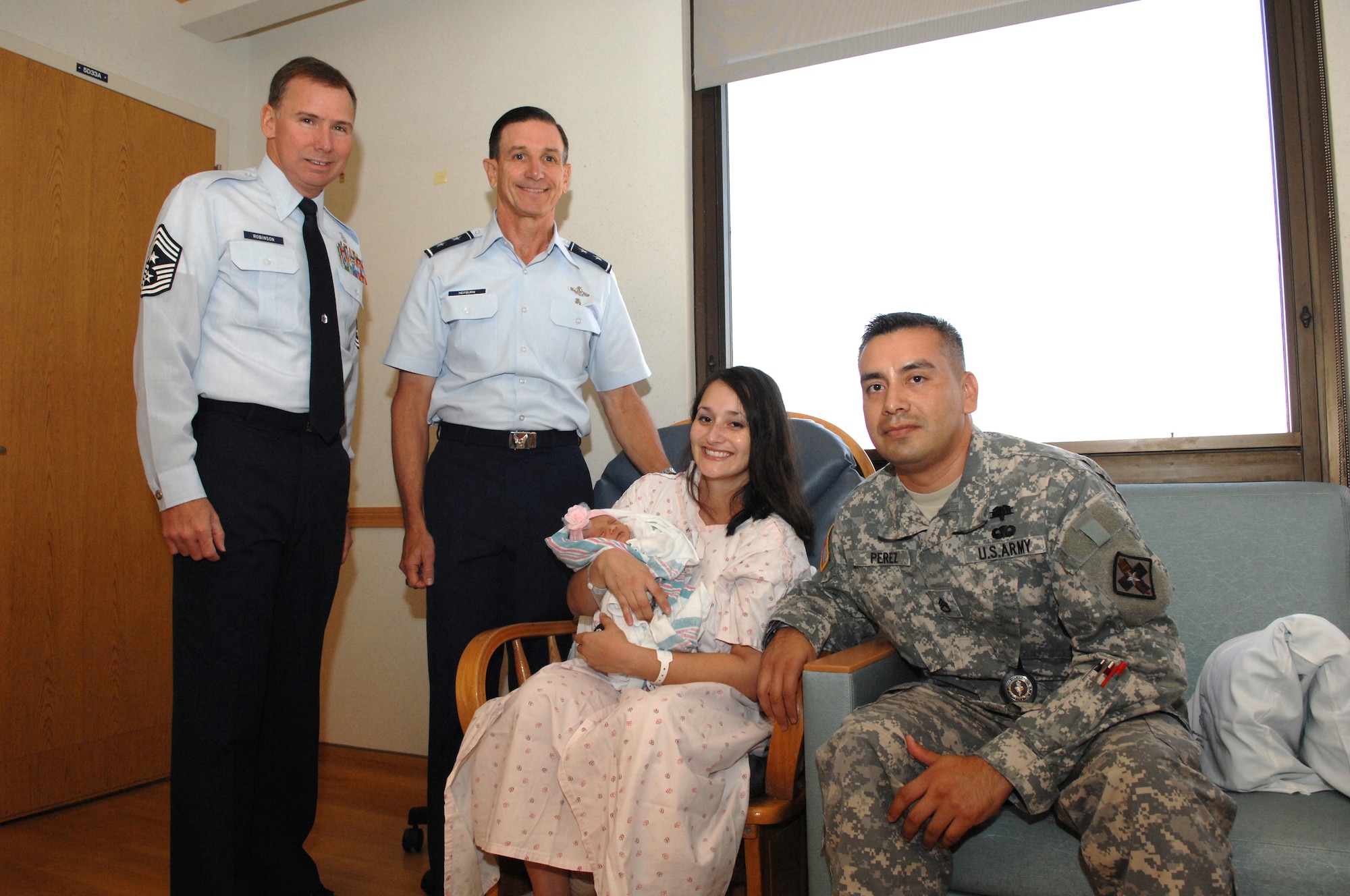 Air Force Chief Master Sgt. Richard Robinson (far left) and Maj. Gen. Byron Hepburn (center left) visit Mrs. Dina Perez, Army Staff Sgt. Mario Perez and baby Laurel Perez, who made history on Aug. 28, 2011. Laurel was the last baby born at Wilford Hall Medical Center. The Hauth Birthing Center closed Aug. 29 and will relocate to a new state-of-the-art birthing center at Fort Sam Houston, Texas. Baby Laurel weighed 5 pounds, 6 ounces and she is 19 inches long. Perez is a nuclear medicine instructor for the Medical Education and Training Campus at Fort Sam. Hepburn is the 59th Medical Wing commander and Robinson is the 59th Medical Wing command chief. (U.S. Air Force photo/Staff Sgt. Robert Barnett) 