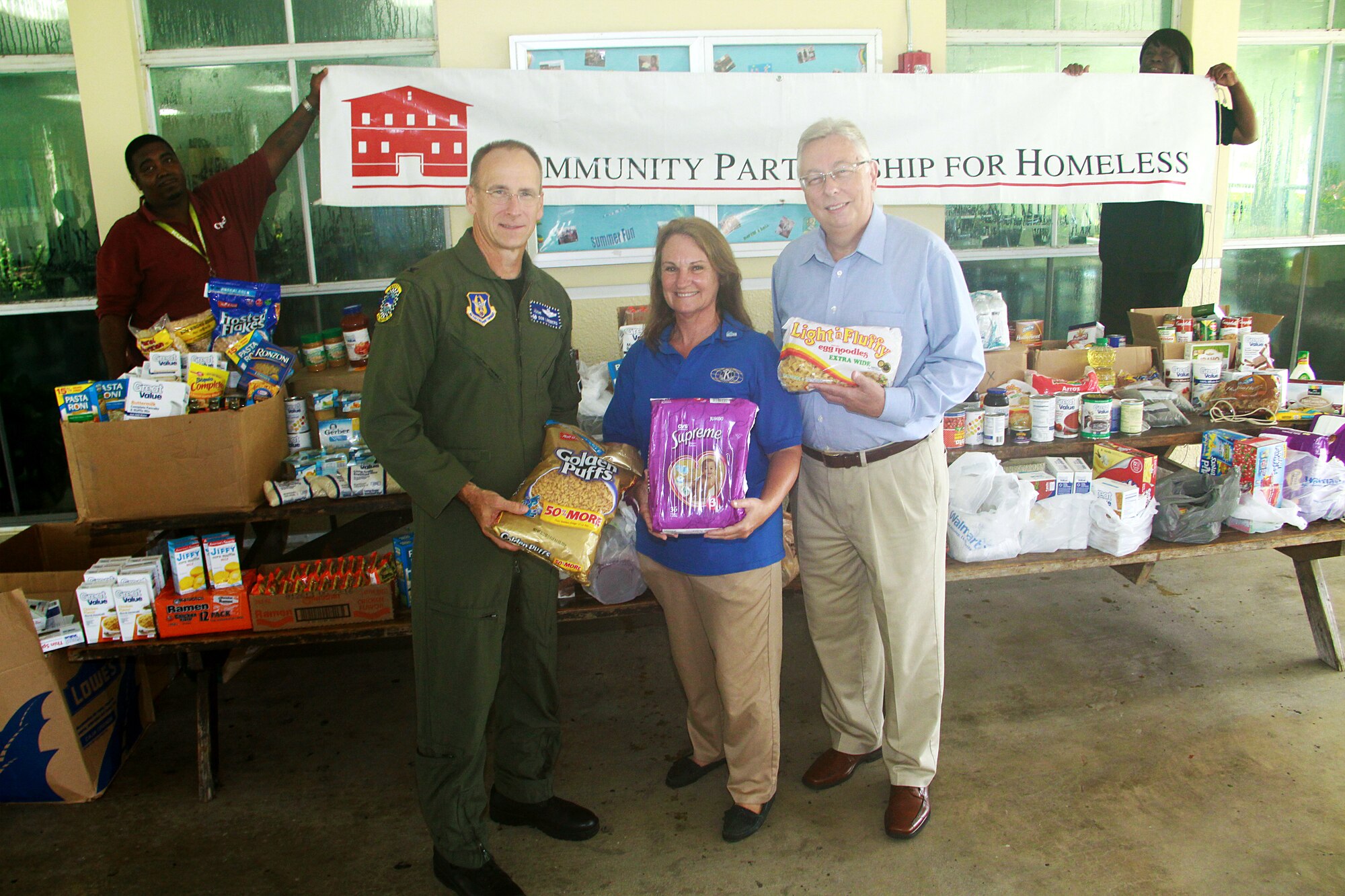 Col. Donald R. Lindberg, Commander, 482nd Fighter Wing, donates over 955 pounds of food and diapers on behalf of the Homestead Air Reserve Base to the Homestead Community Partnership for the Homeless on Aug 31. On hand to accept the donations were Ms. Sharon Saxton, HCPH community liaison, and Mr. Daniel Vincent, CEO of Community Partnership for the Homeless.