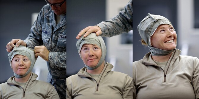 TRAVIS AIR FORCE BASE, Calif. -- Staff Sgt. Gerald Aksland, structures journeyman, practices applying a bandage to Tech. Sgt. Leanne Converse, heavy equipment operator, during Self Aid Buddy Care Training at the 349th Civil Engineer Squadron, Aug. 7, 2011. (U.S. Air Force photo / Lt. Col. Robert Couse-Baker)