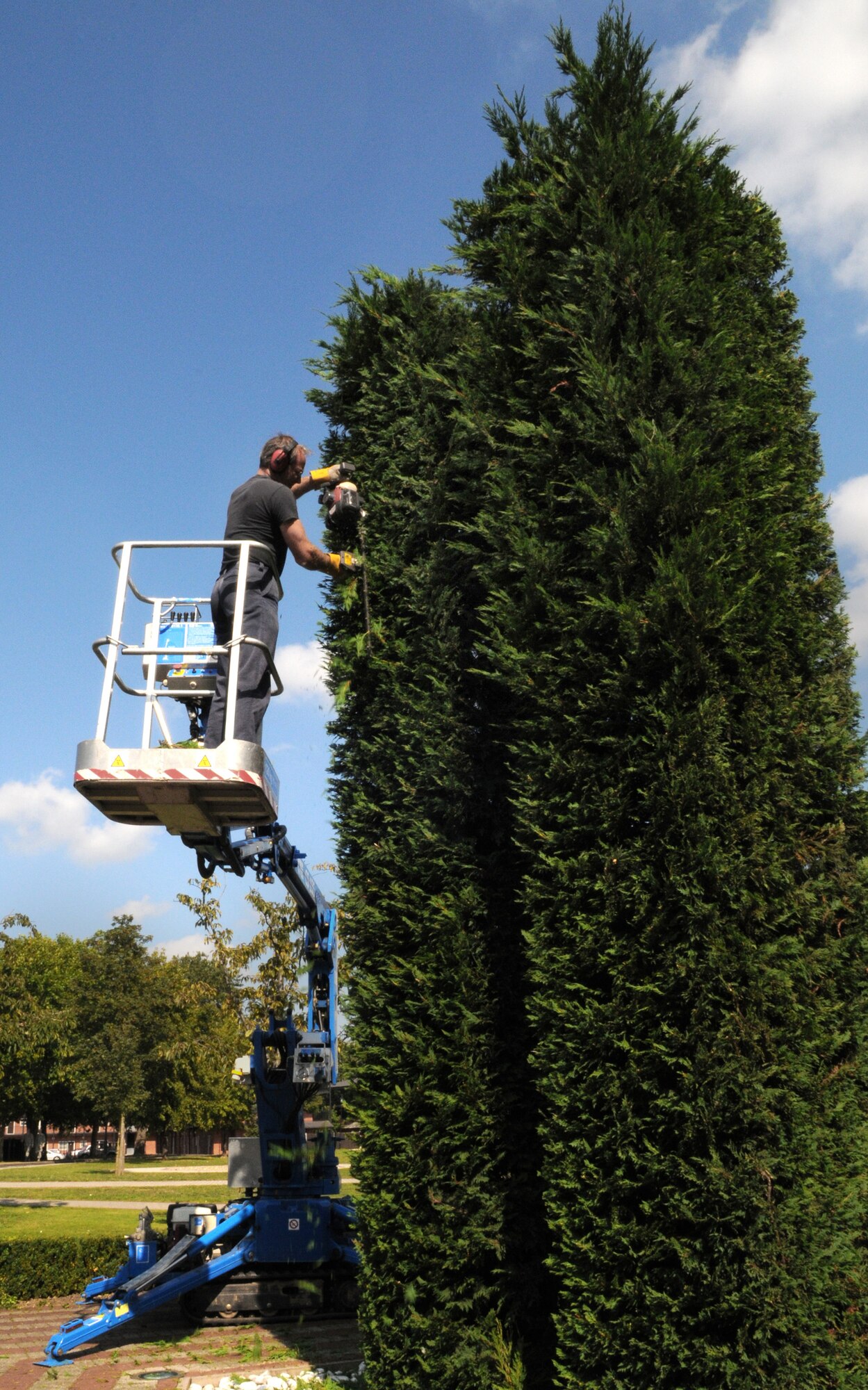 RAF MILDENHALL, England -- Gary Brown, a local contractor, trims hedges at the memorial near the Bob Hope Community Center here Sept. 8, 2011. The two tall hedges represent the twin towers of the World Trade Center that were attacked by terrorists Sept. 11, 2001. Patriot Day events will be held at the memorial Sept. 9 at 8:30 a.m., and will include: a formation of Team Mildenhall firefighters and security forces; a brief moment of silence at 8:46 a.m. to signify when the first plane struck the first tower; and Pledge of Allegiance led by children from Lakenheath Elementary School and childhood development center. (U.S. Air Force photo/Staff Sgt. Thomas Trower)