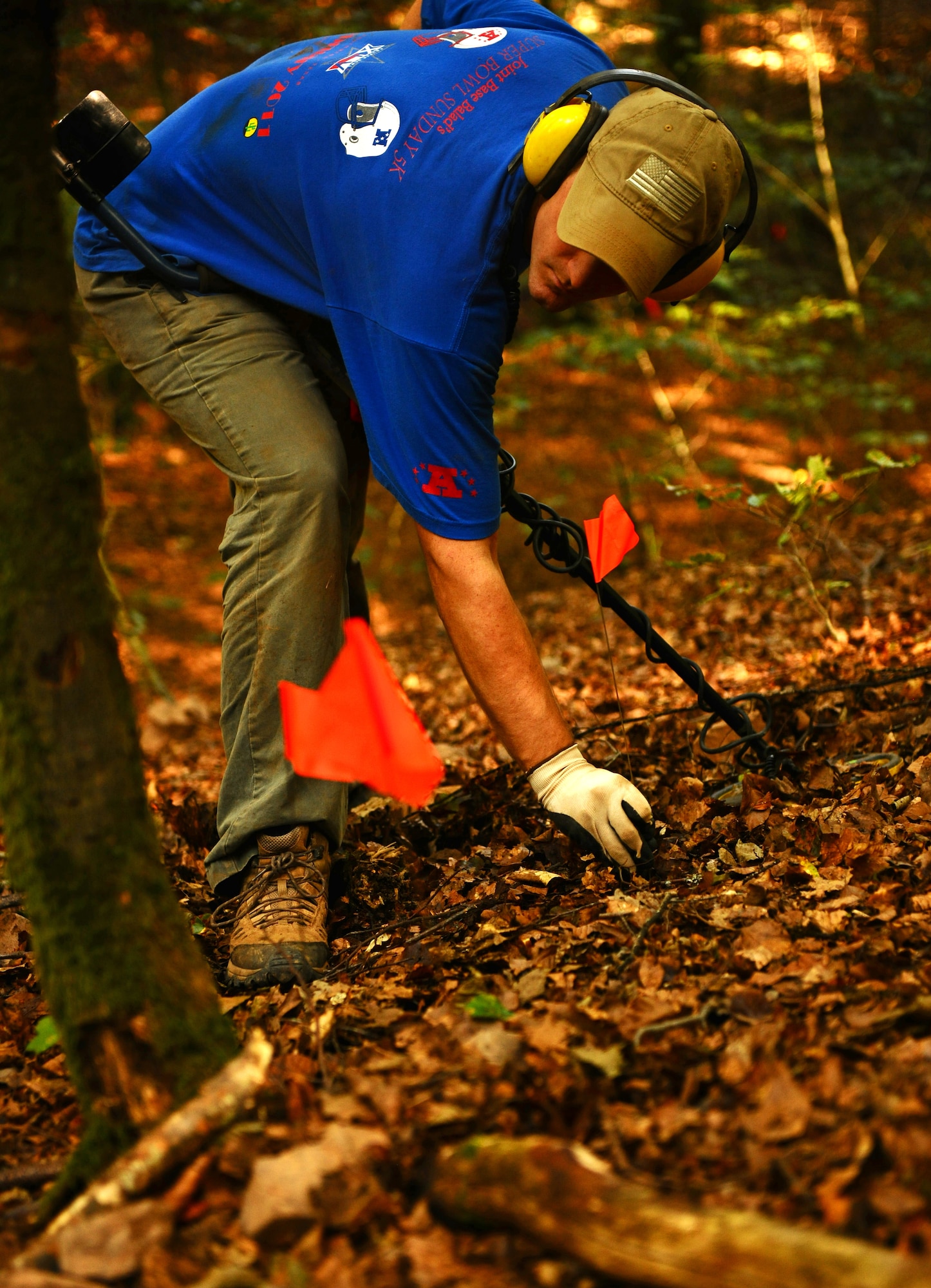 BETTENFELD, Germany -- U.S. Air Force Staff Sgt. James Wagnild, Joint POW/MIA Accounting Command, Honolulu, places an indicator flag after discovering metal beneath the soil with a metal detector at a possible dig site here Sept. 2. Members of JPAC teamed up with U.S. volunteers from Spangdahlem Air Base to find two missing service members from a World War II aircraft crash. The mission of JPAC is to achieve the fullest possible accounting of all Americans missing as a result of the nation’s past conflicts. (U.S. Air Force photo/Staff Sgt. Nathanael Callon)