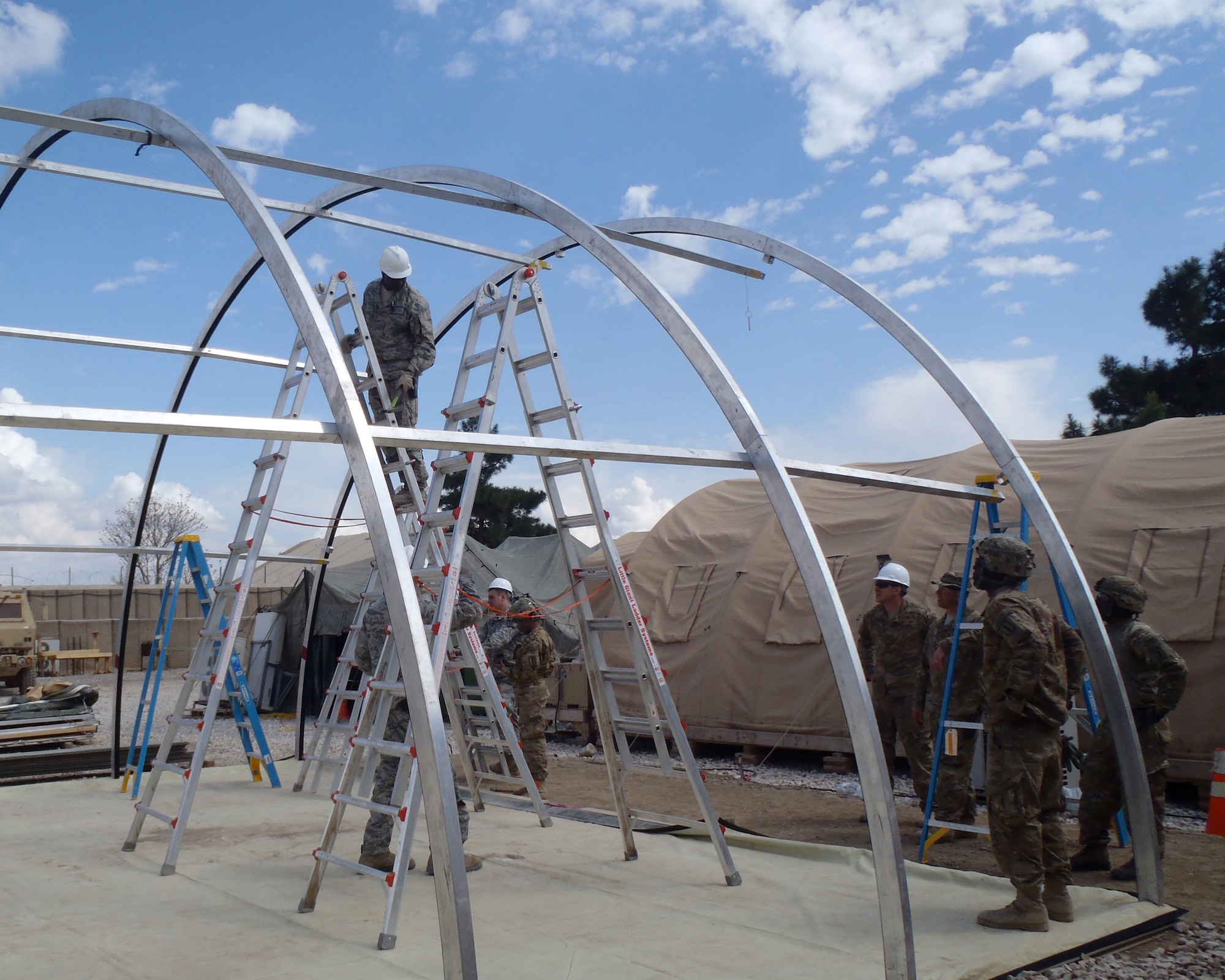MAZAR-E-SHARIF, Afghanistan -- Airmen from the 877th Prime BEEF Squadron and Army Soldiers set up a California tent as part of a Dining Facility extension at Forward Operating Base Kunduz in April 2011. (Courtesy Photo)