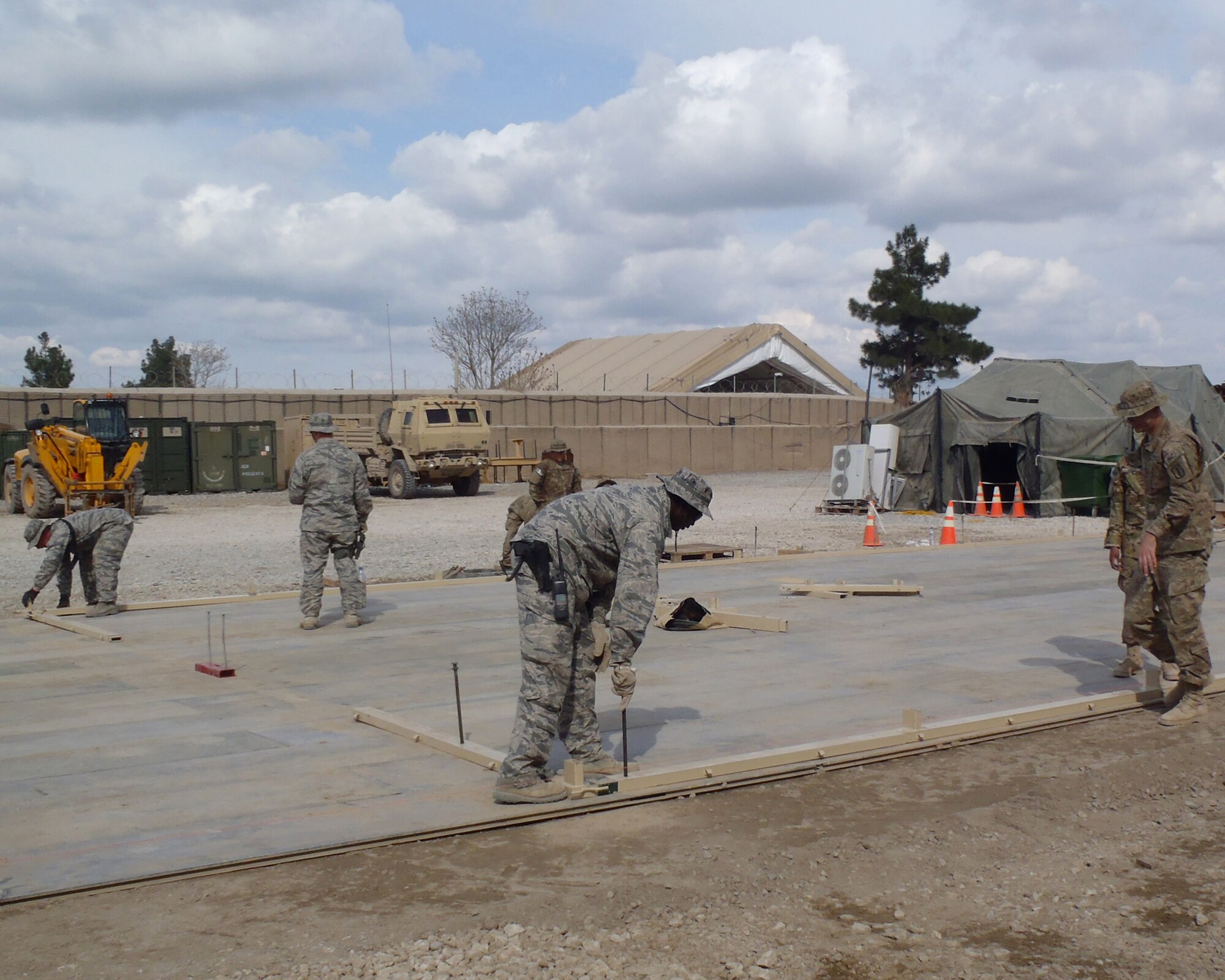 MAZAR-E-SHARIF, Afghanistan -- Airmen from the 877th Prime BEEF Squadron and Army Soldiers set up a California tent as part of a Dining Facility extension at Forward Operating Base Kunduz in April 2011. (Courtesy Photo)