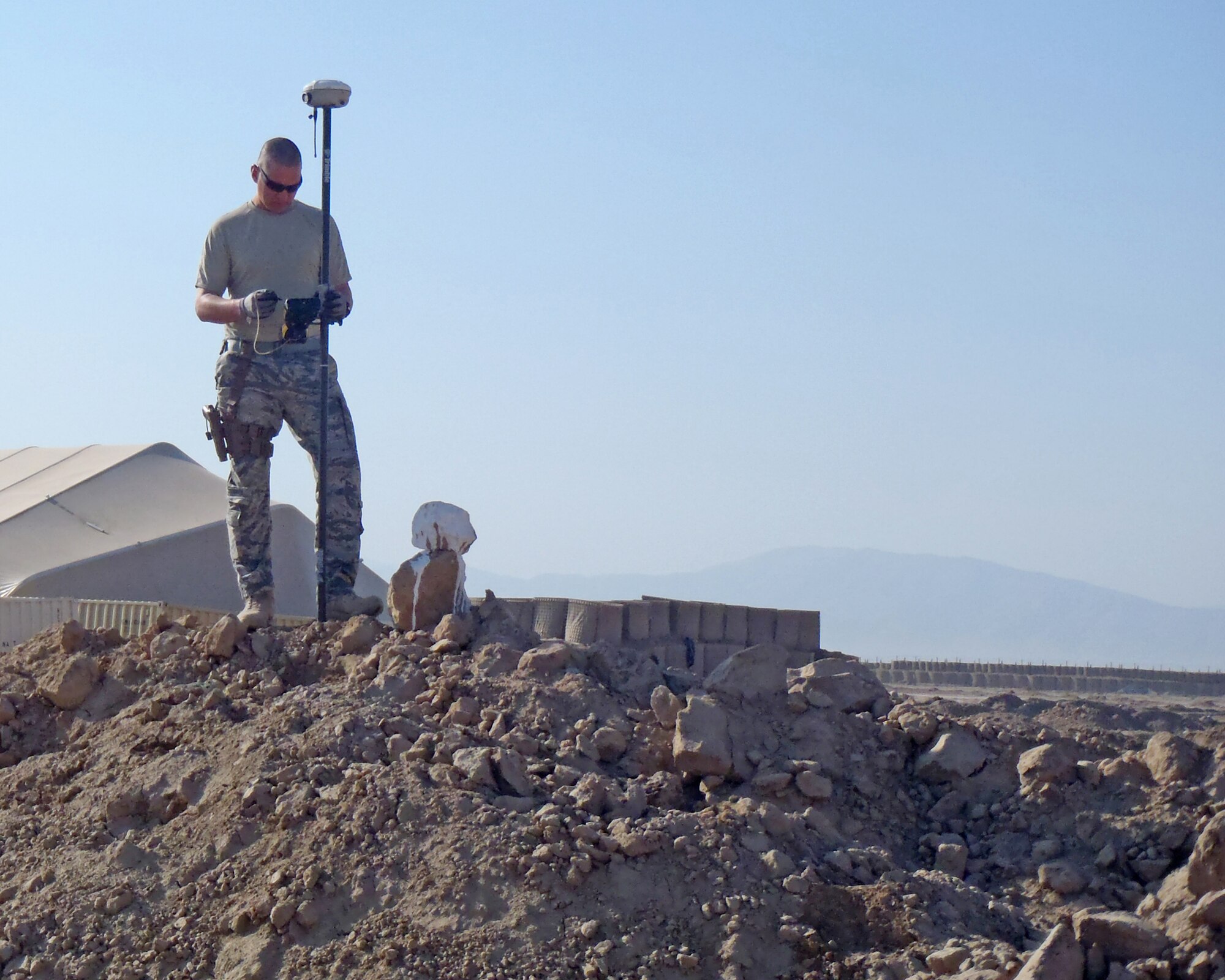 MAZAR-E-SHARIF, Afghanistan -- Master Sgt. Kirk Sherry, 177th Civil Engineer Squadron noncommissioned officer in charge, stakes out boundaries for a fire scout site at Forward Operating Base Kunduz in April 2011. (Courtesy Photo)
