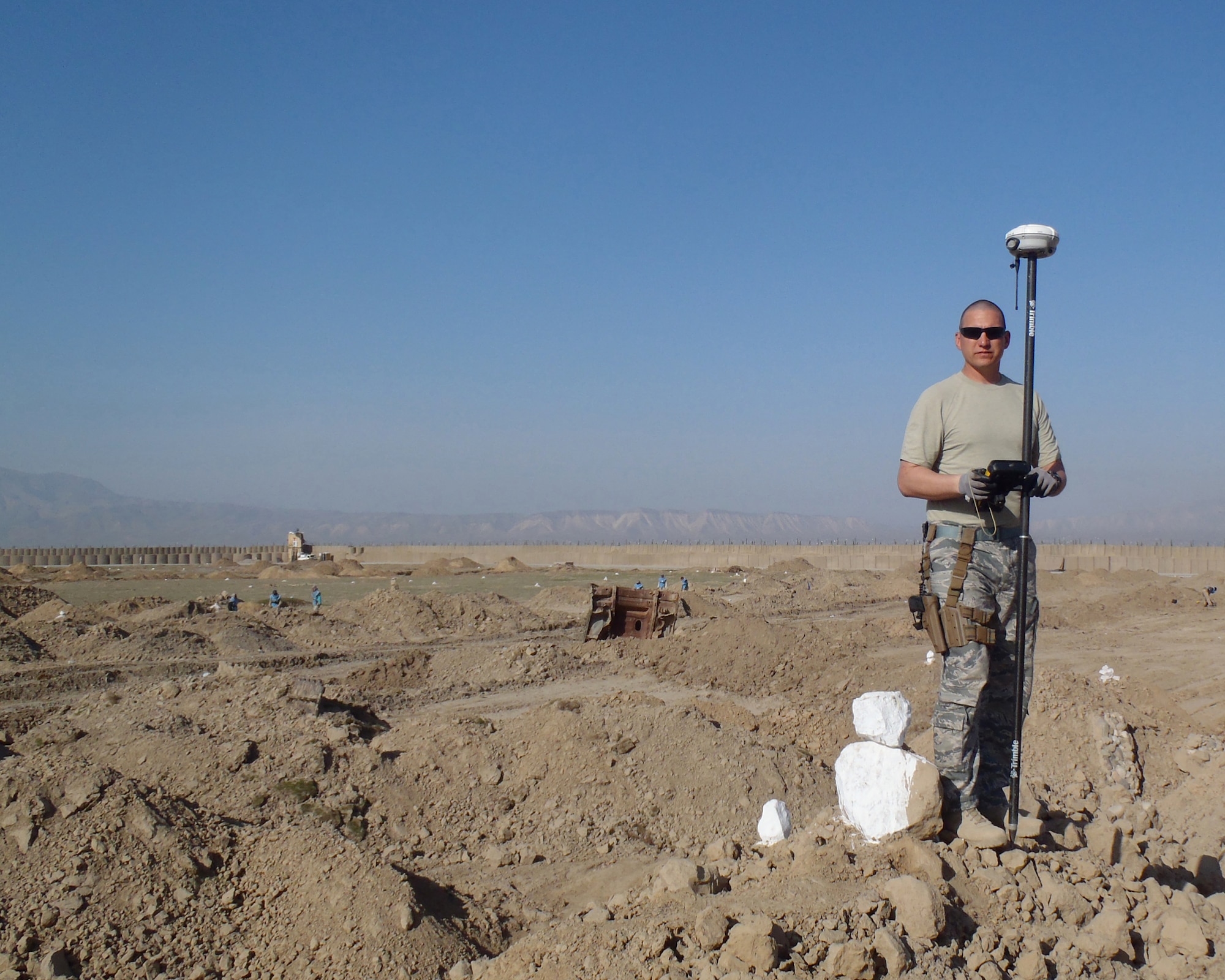 MAZAR-E-SHARIF, Afghanistan -- Master Sgt. Kirk Sherry, 177th Civil Engineer Squadron noncommissioned officer in charge, stakes out boundaries for a fire scout site at Forward Operating Base Kunduz in April 2011. (Courtesy Photo)