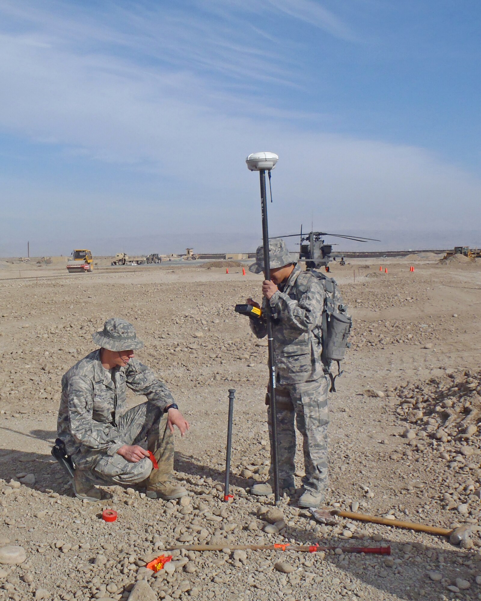 MAZAR-E-SHARIF, Afghanistan -- Senior Airman Mathew Greene, 184th Civil Engineer squadron structures journeyman, and Staff Sgt. Bernard Cortes, 177th Civil Engineer Squadron structures craftsman, lay out grade stakes for the largest Aluminum Matting-2 heliport in Prime Base Engineer Emergency Force history at Forward Operating Base Kunduz in April 2011.  (Courtesy Photo)
