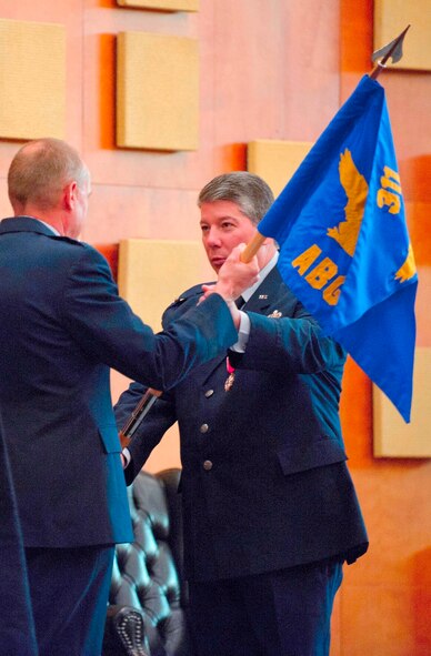 AFMC commander Gen. Donald J. Hoffman (left) accepts the guidon of the 311th Air Base Group from Col. Harry R. Kimberly III, the last commander at Brooks, at the inactivation ceremony. (U.S. Air Force photo/Steve Thurow)