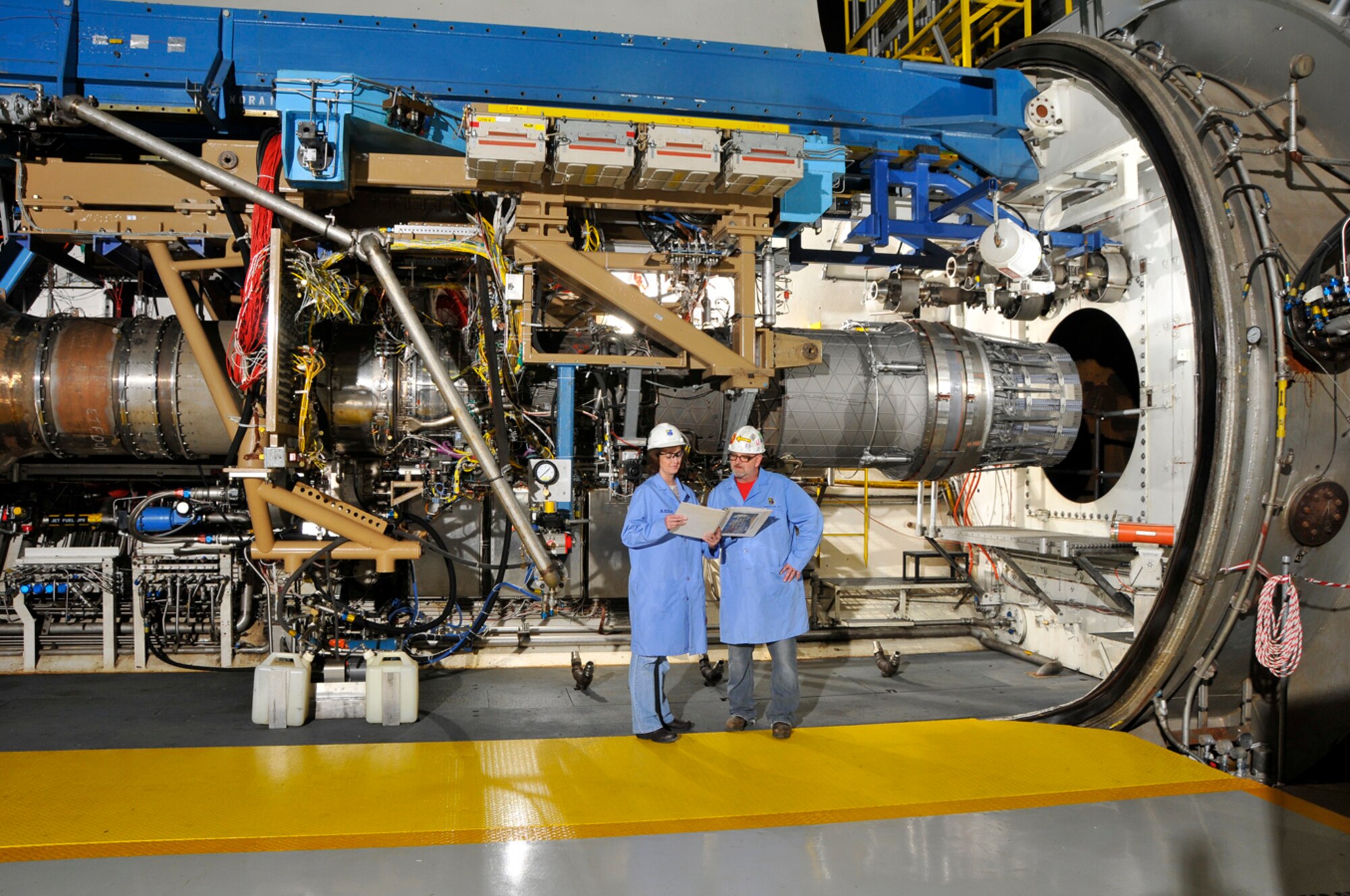 From left, Joan Clark, ATA instrument technician lead, and Paul Buckner, ATA working foreman, verify locations of instrumentation for troubleshooting discrepancies during a break in a test run of a F100 engine in AEDC’s J-1 test cell. (Photo by Rick Goodfriend)