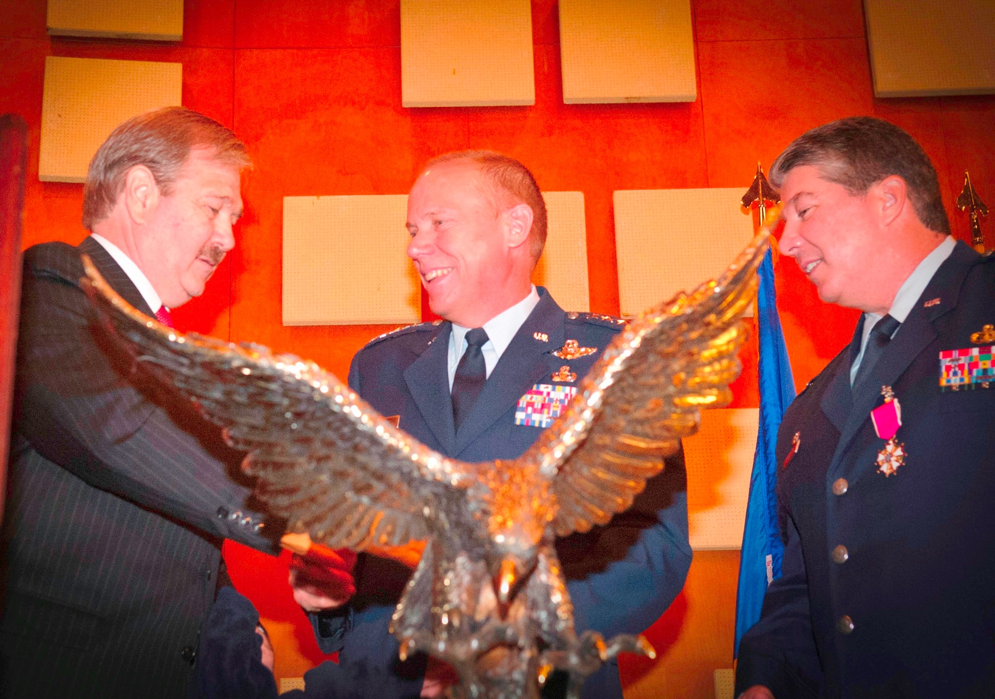 Donald E. Jakeway (left), president and CEO of the Brooks Development Authority, presents AFMC with a brass rendition of a landing eagle in appreciation of the command’s support as Brooks transitioned towards closure.   AFMC Commander Gen. Donald J. Hoffman (center) accepts the trophy on behalf of the command, as Col. Harry R. Kimberly III, 311th Air Base Group commander, observes.  (U.S. Air Force photo/Steve Thurow)
