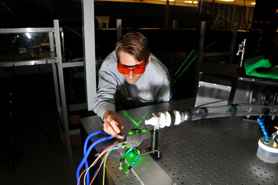 Dr. Todd Lowe, Applied University Research, Inc., Vice President for research and development inspects a sub-miniature laser Doppler velocimetry (SM LDV) system before it was installed in a small wind tunnel for a test at AEDC. (Photo by Rick Goodfriend)