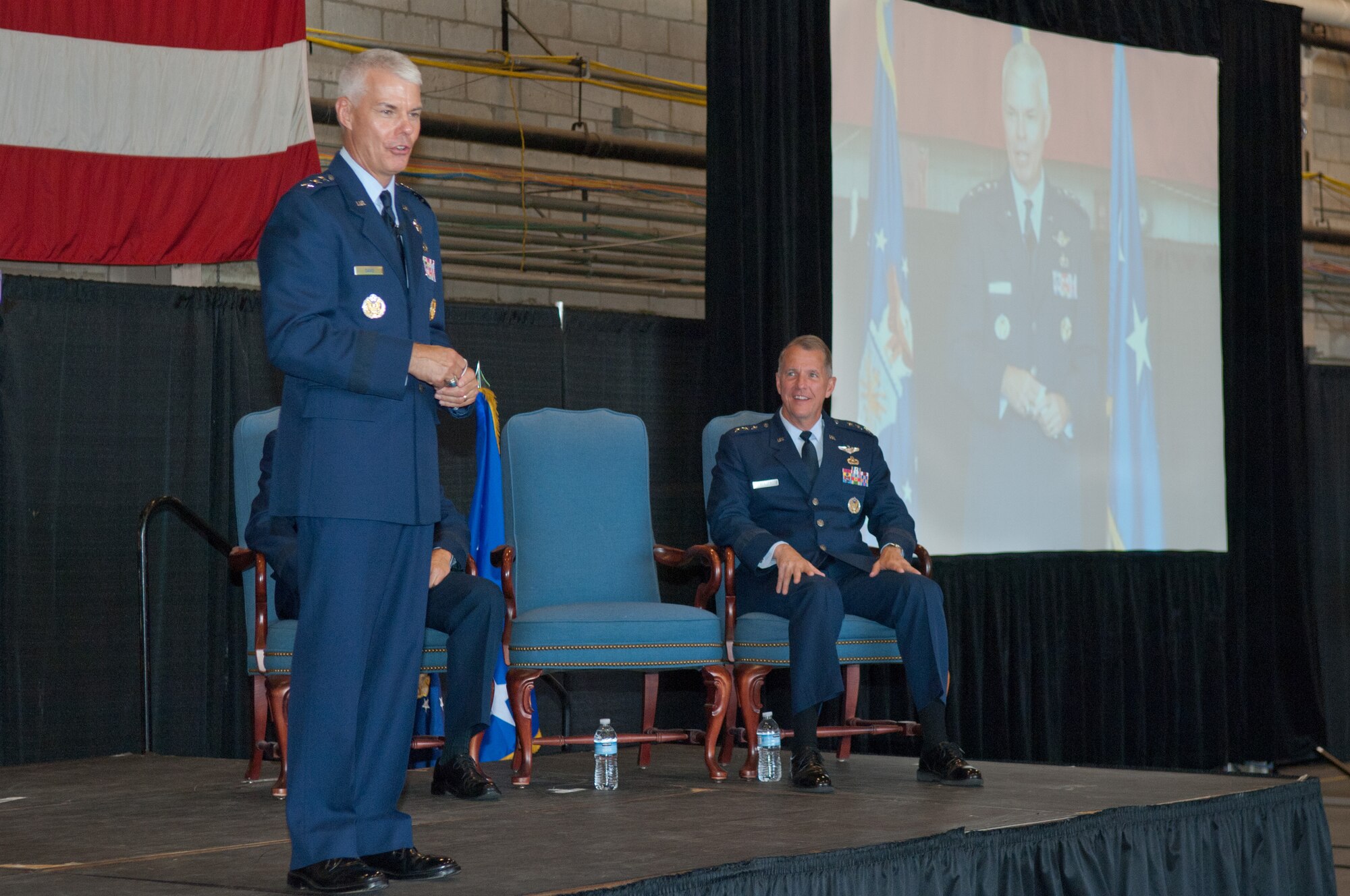 Incoming Electronic Systems Center Commander Lt. Gen. Charles (C.R.) Davis speaks to the audience during the change of command ceremony Sept. 1 in the Aero Club Hangar, while outgoing commander Lt. Gen. Ted Bowlds looks on. General Davis moved to ESC from the Air Armament Center, where he served as commander and as the Air Force program executive officer for Weapons, at Eglin AFB, Fla. Prior to leading the Air Armament Center, General Davis was program executive officer for the F-35 Lightning II Program Office. General Bowlds served as ESC commander for nearly four years and is retiring from the Air Force after more than 36 years of service. (U.S. Air Force photo by Rick Berry)