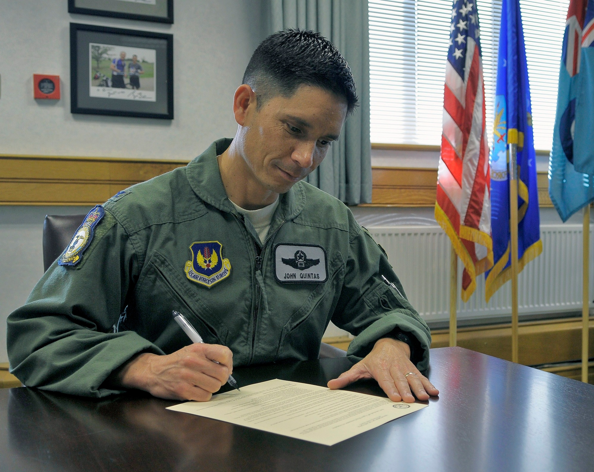 ROYAL AIR FORCE LAKENHEATH, England - Col. John Quintas, 48th Fighter Wing commander, signs the Suicide Prevention Week proclamation Sept. 1, 2011. This proclamation recognizes suicide as an Air Force-wide public health problem, suicide prevention as an Air Force responsibility and designates Sept. 4 through 10 as Suicide Prevention Week at RAF Lakenheath. (U.S. Air Force photo by Staff Sgt. Connor Estes)
