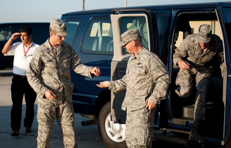 Capt. Jonathan Murphy, 39th Air Base Wing chief of protocol, hands ear plugs to Col. Chad Butts, 39th Air Base Wing vice commander, before greeting a distinguished visitor Aug. 24, 2011, on the flightline at Incirlik Air Base, Turkey. (U.S. Air Force photo by Airman 1st Class Clayton Lenhardt/Released)