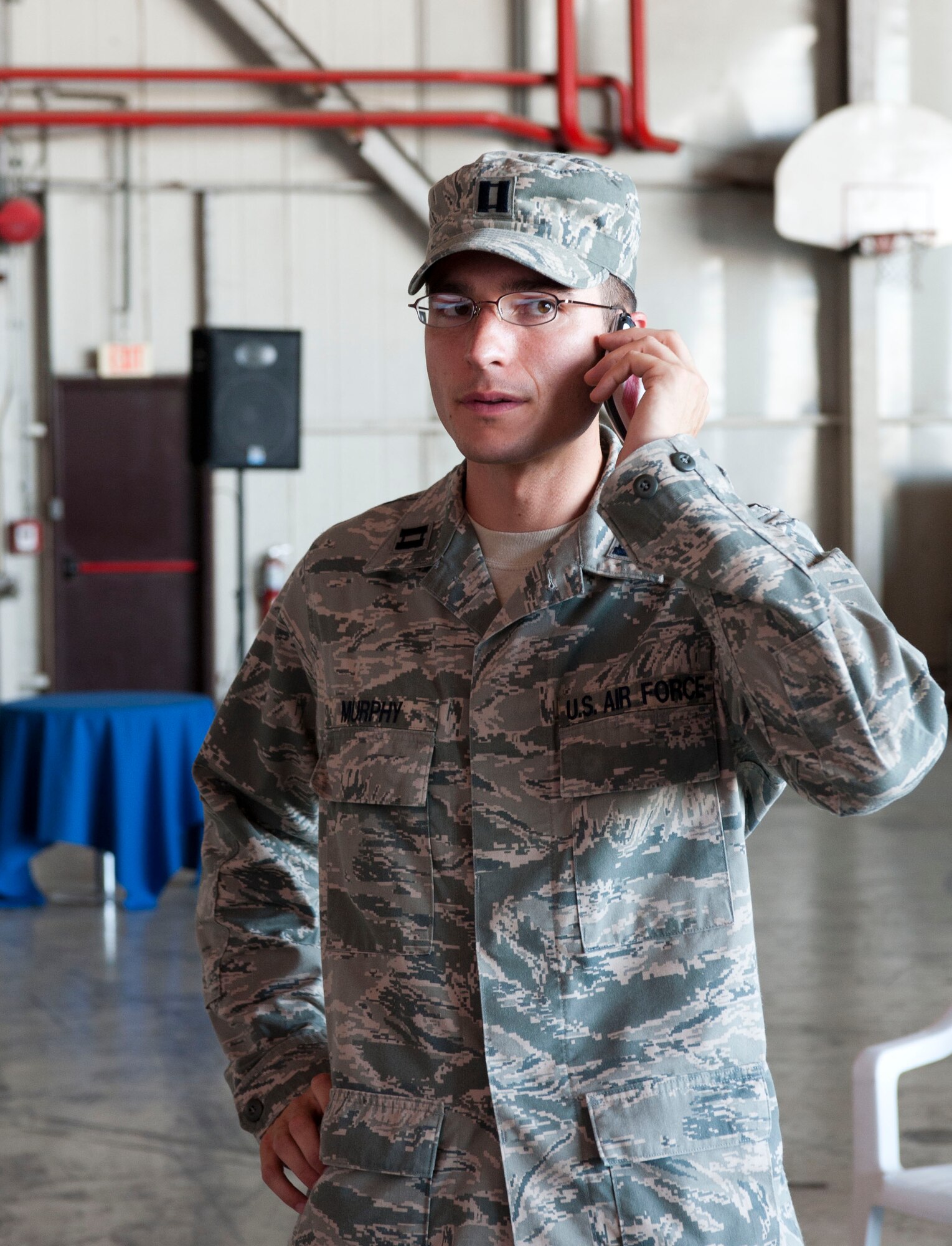 Capt. Jonathan Murphy, 39th Air Base Wing chief of protocol, answers a phone call while setting up a practice for an assumption-of-command ceremony Aug. 24, 2011 at Incirlik Air Base, Turkey. (U.S. Air Force photo by Airman 1st Class Clayton Lenhardt/Released)
