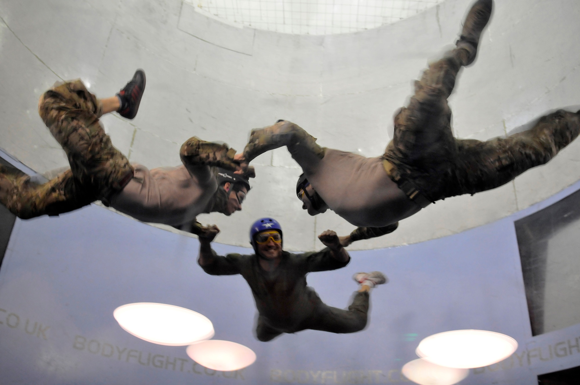 BEDFORD, England -- Pararescuemen from the 56th Rescue Squadron practice free fall maneuvers during advanced free fall skills and wind tunnel training Aug. 25, 2011. As "Guardian Angel" operators, the Airmen are tasked with the recovery and medical treatment of personnel in both humanitarian and combat environments, often employing free fall parachuting systems that require an advanced degree of skill and body control. The purpose of the simulated free fall is to practice body position, stability, emergency procedures and link up procedures in a controlled environment. (U.S. Air Force photo by Senior Airman Lausanne Morgan)