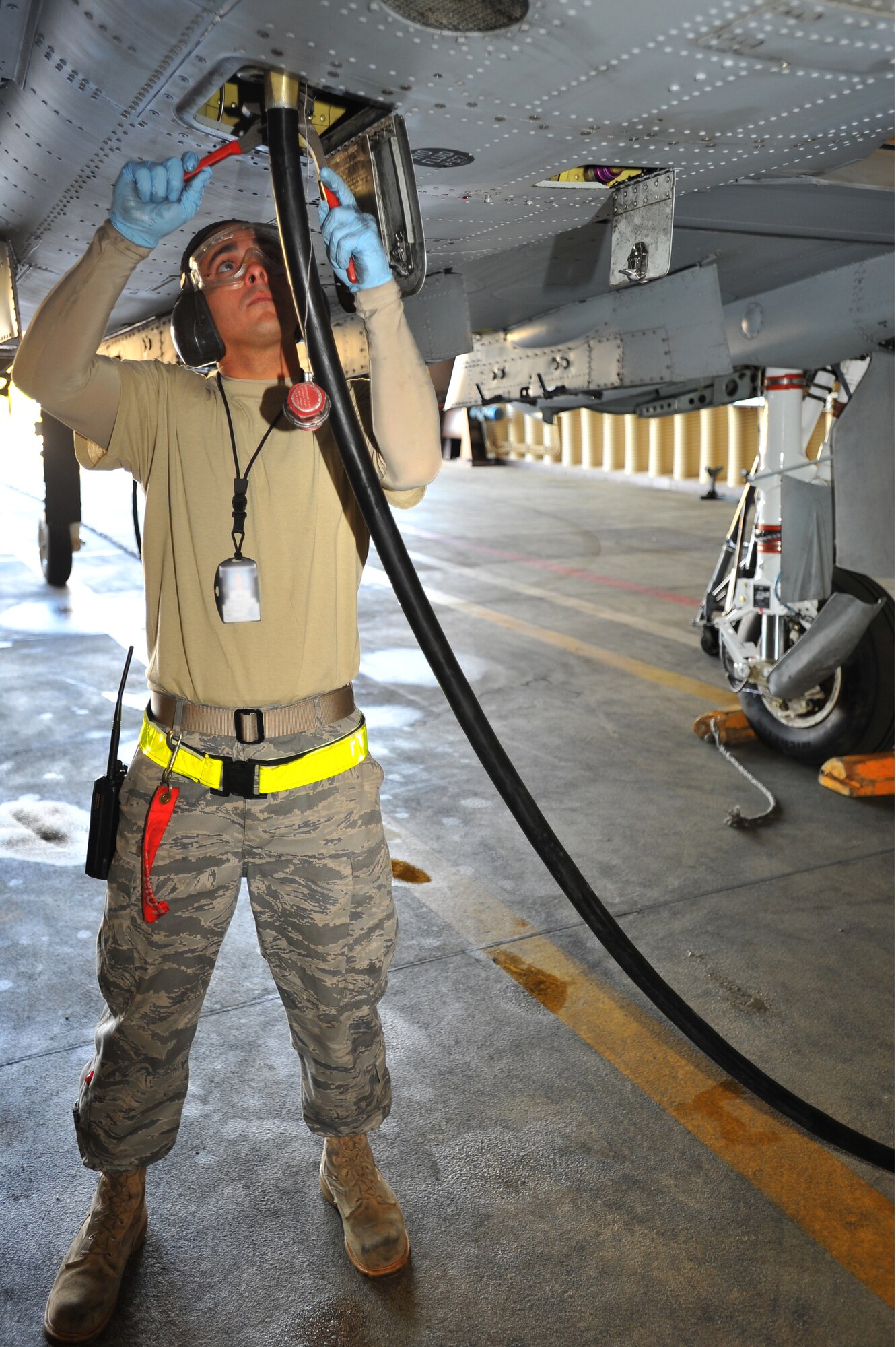 SPANGDAHLEM AIR BASE, Germany – Staff Sgt. Joshua Talpas, 81st Aircraft Maintenance Unit crew chief, removes a fuel drainage hose from an A-10 Thunderbolt II before scheduled maintenance here Aug. 30. The 81st AMU delivers precise and reliable maintenance to continually support the capabilities of the 81st Fighter Squadron’s flying mission. (U.S Air Force photo/Airman 1st Class Dillon Davis)