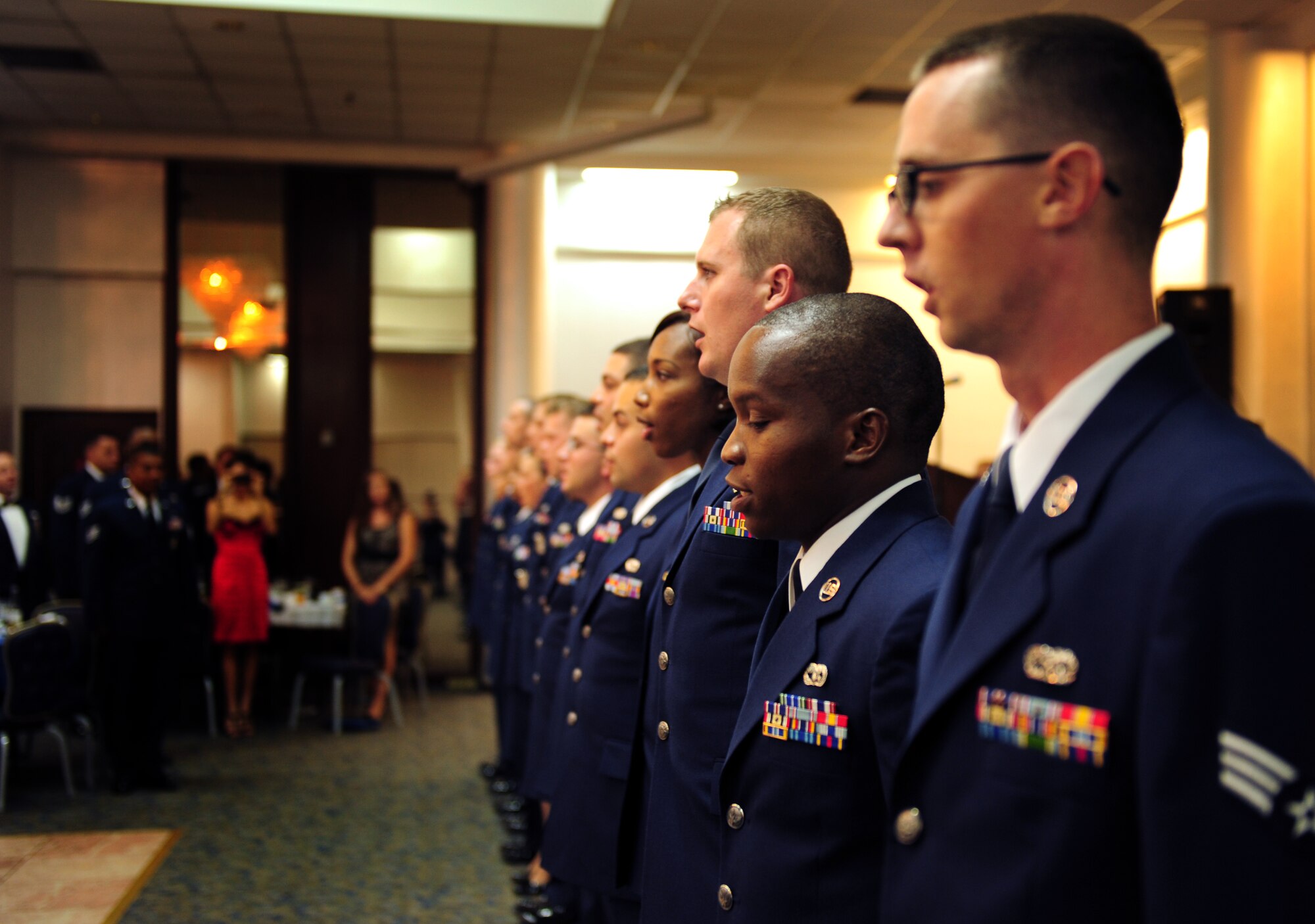 Incirlik Airman Leadership School graduates sing the Air Force song after the ALS graduation ceremony Sept. 1, 2011, in the Club Complex at Incirlik Air Base, Turkey. ALS is one of four professional military education courses in the Air Force that prepares NCOs or future NCOs for increased responsibilities. The graduates of Class 11-7 were Staff Sgts. Billy Lei and Jason Johnson, and Senior Airmen Mohamed Bah, Ernest Benavides, Leslie Berrian, Daniel Brintzenhoff, Michael Buchanan, Isaiah Combs, Amanda Giddins, Deaniel Jensen, James Jorge, Jordan Layton, Jessica Mitchum, Michael Mumau, and Clayton Warren. (U.S. Air Force photo by Senior Airman Anthony Sanchelli/Released)
