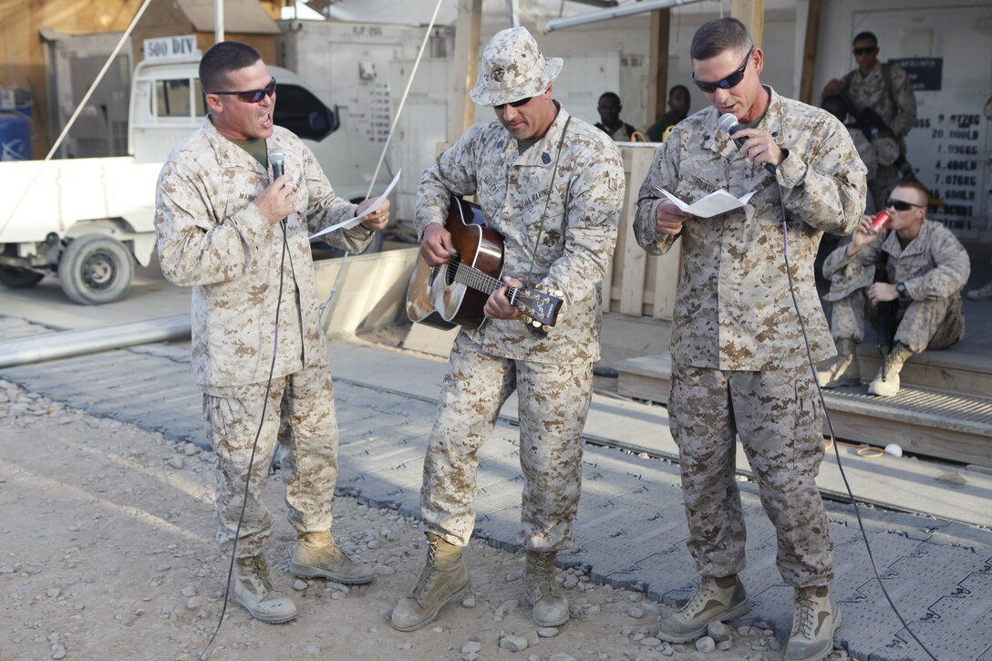 The command of Marine Aviation Logistics Squadron 40 sings a song about the change of the squadron’s name back to the Smokin’ Aces at Camp Bastion, Afghanistan, Sept. 3. The song made reference to the squadron’s old name, the Thoroughbreds, to the tune of “A Horse with No Name.” The song was only a small part of the celebration which included food, music and sporting events for Marines to enjoy.