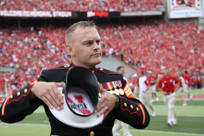 Sgt. Joshua Benne shows his enthusiasm for Nebraska football. Benne is a Lincoln native and combat veteran honored at Opening Day, Sept. 3. He joined the team captains in the coin toss and was recognized in a Marine Corps tribute. Benne is the NCOIC for Recruiting Sub-station Dubuque, Iowa. ::r::::n::