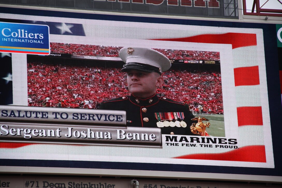 Sgt.Joshua Benne, stands on the field at Memorial Stadium and is featured on the "Husker-vision" in front of 85,000 fans. Sgt. Benne is a Lincoln native and combat veteran honored at Opening Day. Benne runs the Recruiting Sub-station in Dubuque, Iowa.
