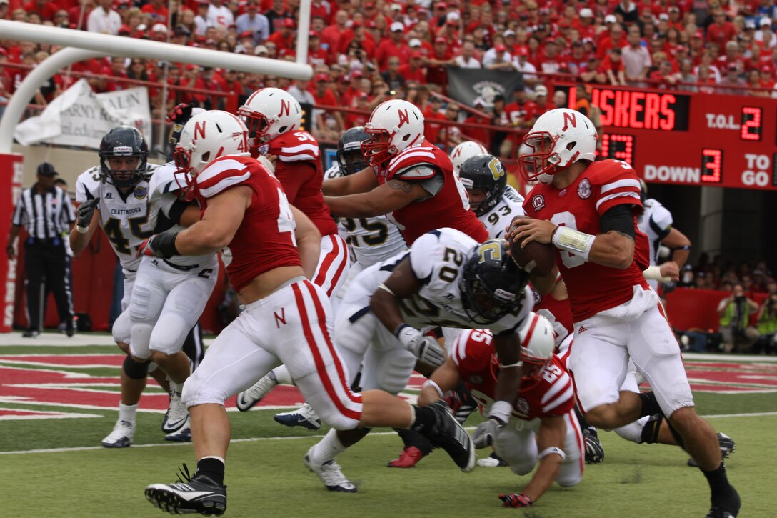 Taylor Martinez, quarterback for the Nebraska Cornhuskers, runs in a touchdown. Sgt. Joshua Benne is a Lincoln native and combat veteran was honored at Opening Day as part of an ongoing salute to the U.S. Marines. Benne runs the Recruiting Sub-station in Dubuque, Iowa.