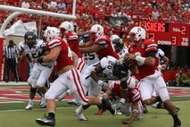 Taylor Martinez, quarterback for the Nebraska Cornhuskers, runs in a touchdown. Sgt. Joshua Benne is a Lincoln native and combat veteran was honored at Opening Day as part of an ongoing salute to the U.S. Marines. Benne runs the Recruiting Sub-station in Dubuque, Iowa.