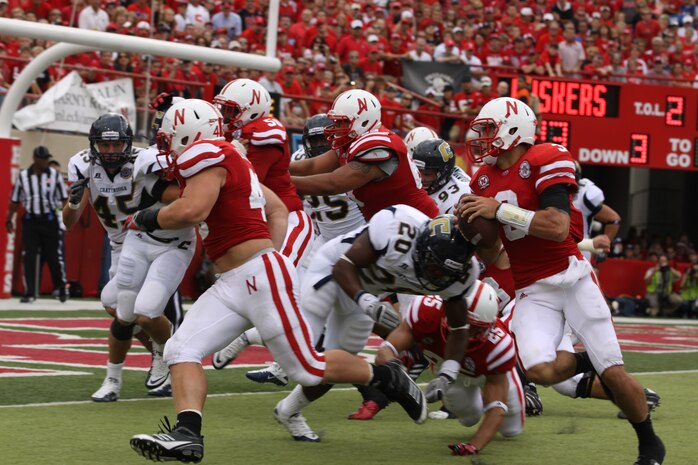 Taylor Martinez, quarterback for the Nebraska Cornhuskers, runs in a touchdown. Sgt. Joshua Benne is a Lincoln native and combat veteran was honored at Opening Day as part of an ongoing salute to the U.S. Marines. Benne runs the Recruiting Sub-station in Dubuque, Iowa.