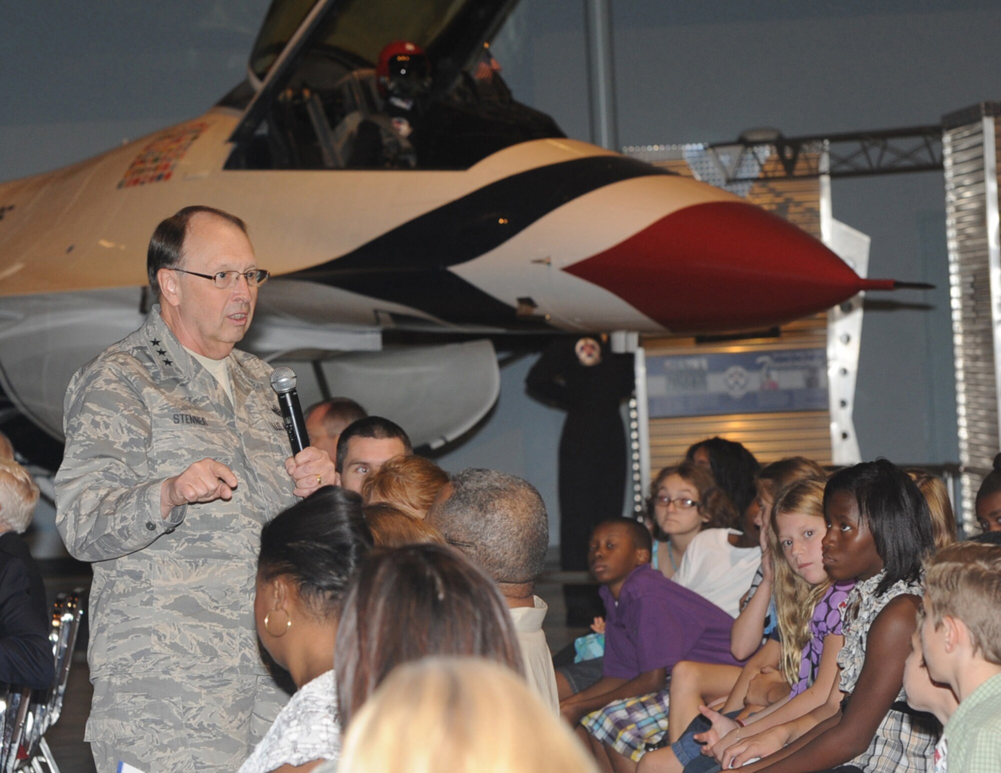 Lt. Gen. Charles E. Stenner Jr., commander of Air Force Reserve Command at Robins Air Force Base, Ga., speaks to fifth graders from the Centerville (Ga.) Elementary School about his former "office" in the cockpit of an F-16.  A Thunderbird F-16 is in the background behind the general. The AFRC commander and Tony Gonzales, director of STARBASE for the Office of the Assistant Secretary of Defense for Reserve Affairs, were guest speakers at STARBASE Robins' 15th anniversary ceremony Sept. 2, 2011. STARBASE is a Department of Defense program begun in 1989 to raise the interest and improve knowledge and skills of students in kindergarten through 12th grade in science, technology, engineering and mathematics. (U.S. Air Force photo/Raymond Clayton Jr.)