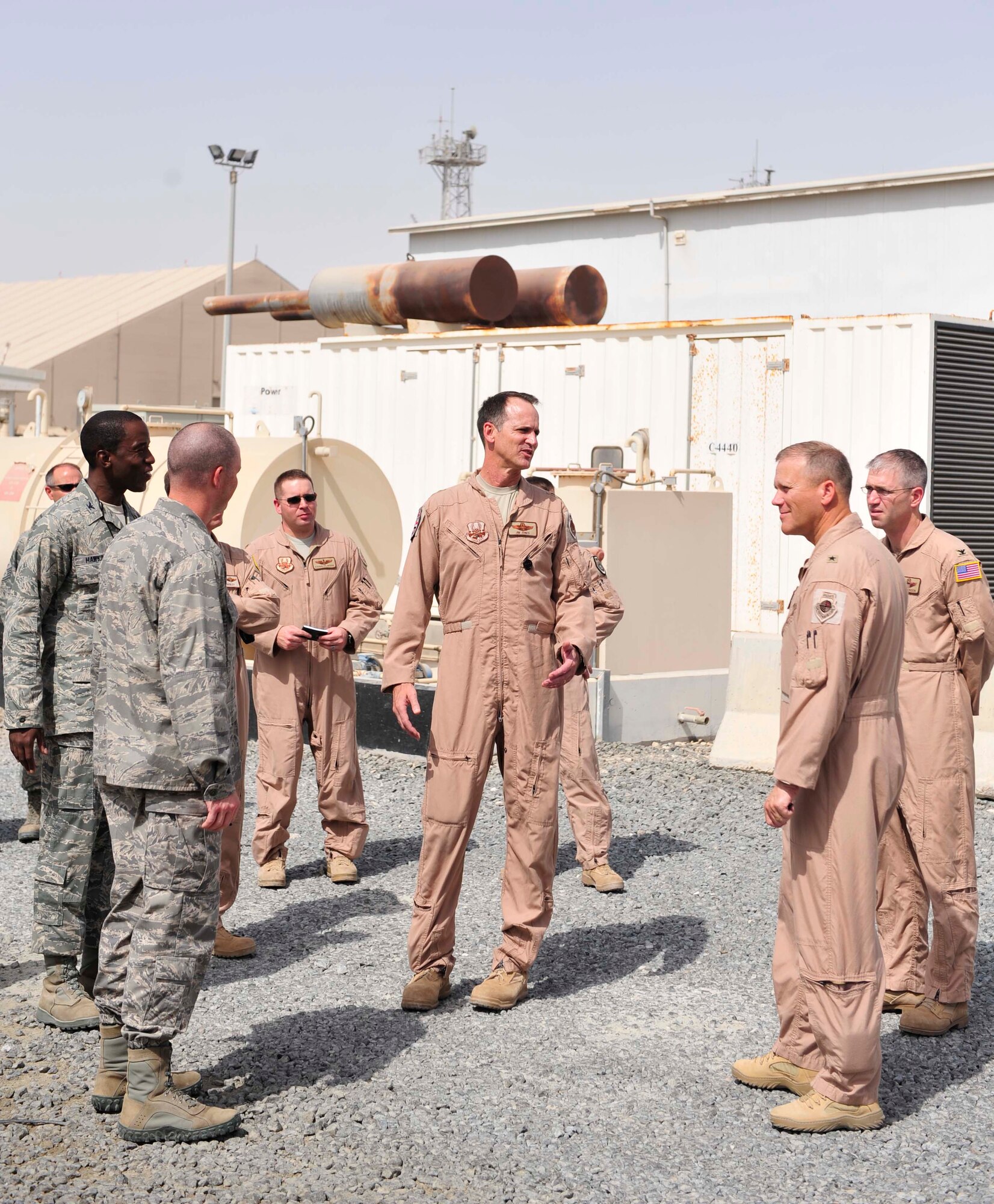 Gen. Jeff Lofgren, the 380th Air Expeditionary Wing commander, leads Maj. Gen.  James J.  Jones, the U.S. Air Forces Central Command deputy commander, on a site visit around the 380th AEW Sep. 2, 2011. Jones visited the base to meet with deployed service members and to learn more about how they support the AFCENT mission.  (U.S. Air Force photo/Tech Sgt. Patrick Mitchell)