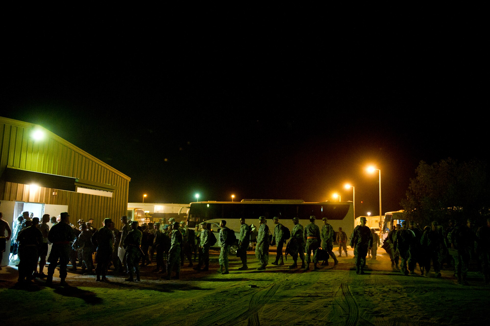 Newly arriving Airmen file into the lodging building to receive briefings and room assignments at a base in Southwest Asia on Aug. 31, 2011. The Airmen will continue to prepare the base, which has been closed for several years, for missions supporting Operation New Dawn. (U.S. Air Force Photo/Master Sgt. Jeffrey Allen)