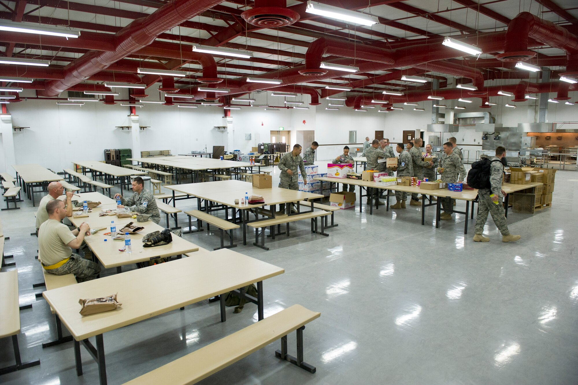 Airmen pick-up breakfast at the recently re-opened dining facility at a base in Southwest Asia on Aug. 24, 2011. Airmen are only provided with Meals Ready to Eat but hot meals are expected to start soon.The base was shut down in 2004 and is re-opening to support Operation New Dawn.  (U.S. Air Force Photo/Master Sgt. Jeffrey Allen)