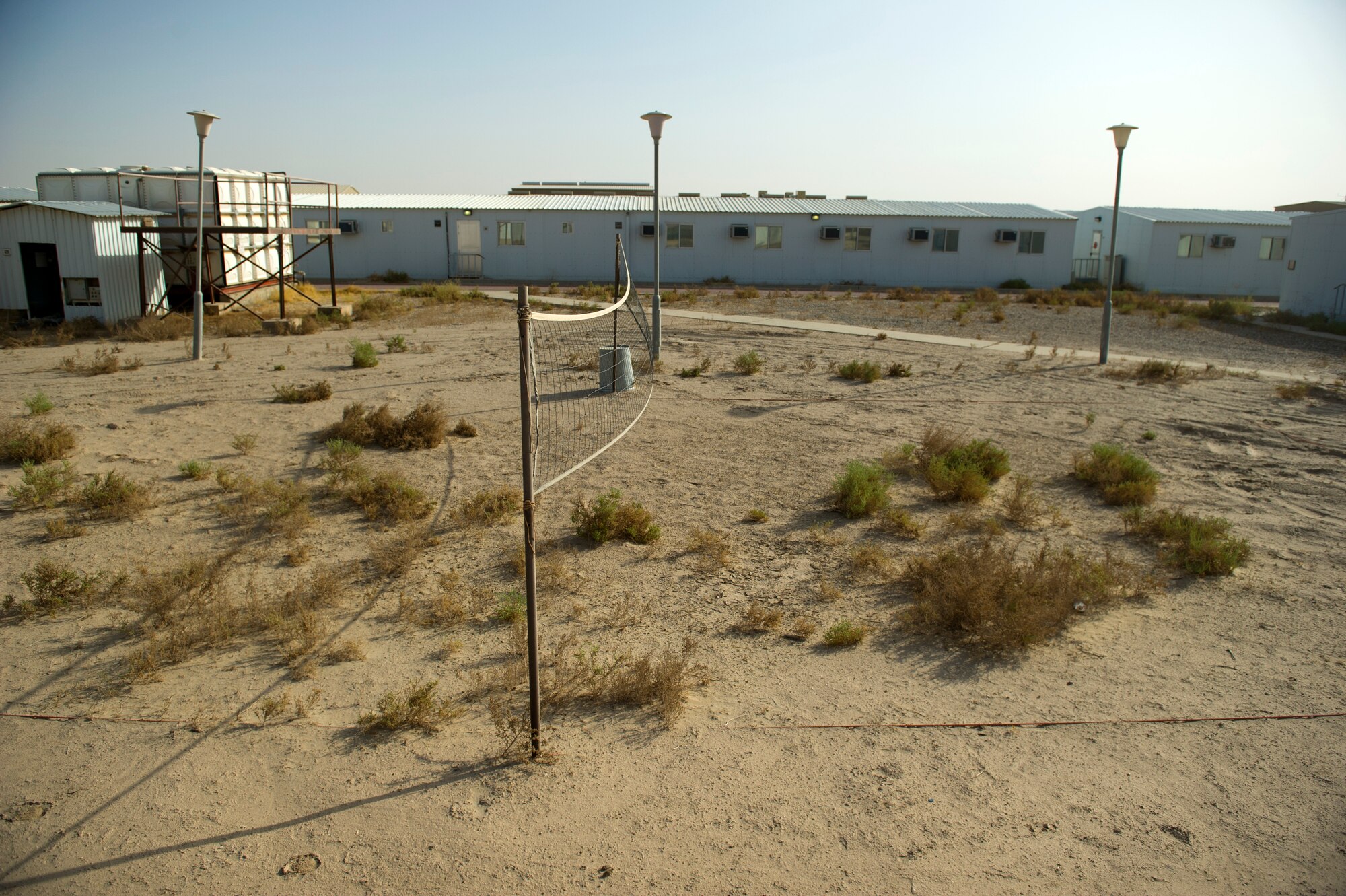 A volleyball court at a U.S. Air Base in Southwest Asia is overgrown with weeds on Aug. 23, 2011.  The court hasn't been used since U.S. Forces closed the base in 2004. The base was formerly the home of the 332nd Air Expeditionary Group which moved to Joint Base Balad, Iraq. Airmen are re-opening the base to conduct missions supporting Operation New Dawn. (U.S. Air Force Photo/Master Sgt. Jeffrey Allen)