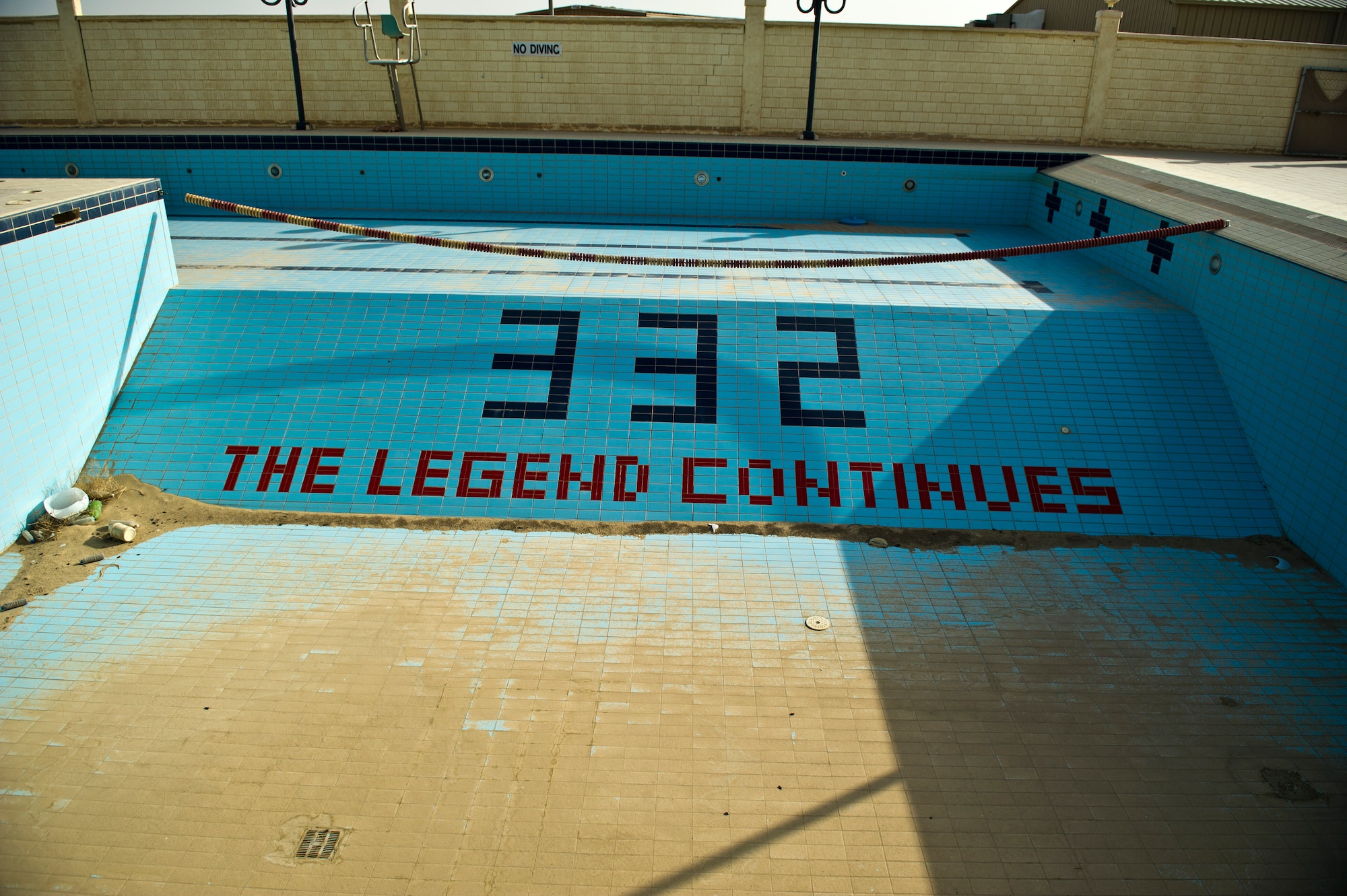 The base pool at an undisclosed location in Southwest Asia, sits empty on Aug. 23, 11.  The empty pool is full of dust and debris because it has not been used since U.S. Forces closed the base in 2004. The base was formerly the home of the 332nd Air Expeditionary Group which eventually moved to Joint Base Balad, Iraq. (U.S. Air Force Photo/Master Sgt. Jeffrey Allen)