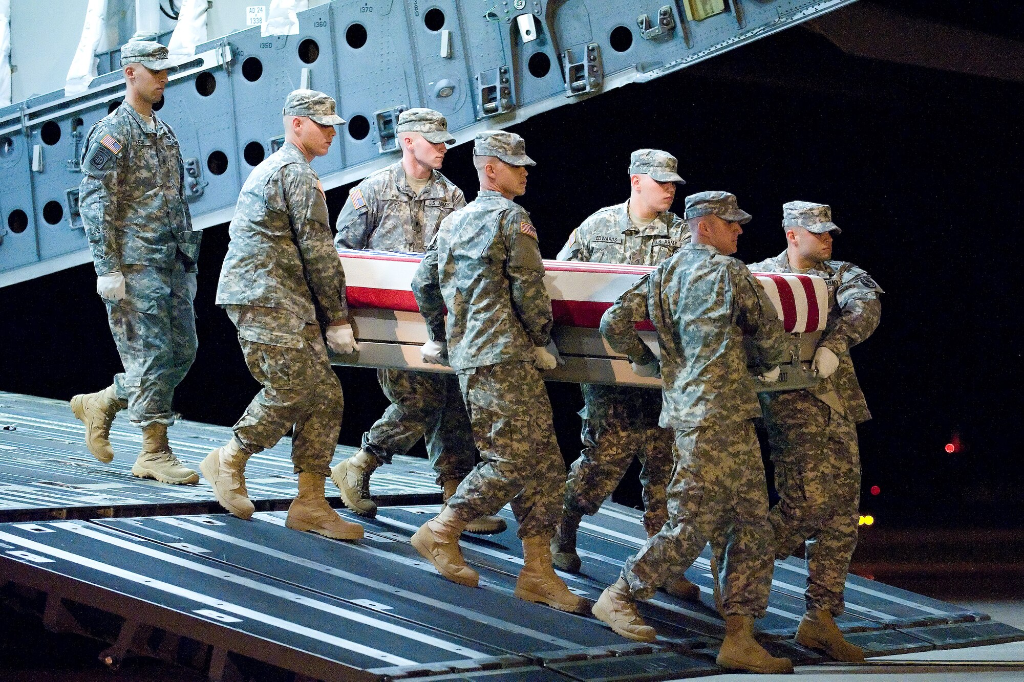 A U.S. Army carry team transfers the remains of Army Spc. Christopher J. Scott of Tyrone, N.Y., at Dover Air Force Base, Del., Sept. 4, 2011. He was assigned to the 716th Military Police Battalion, 101st Sustainment Brigade, 101st Airborne Division (Air Assault), Fort Campbell, Ky. (U.S. Air Force photo/Adrian Rowan)