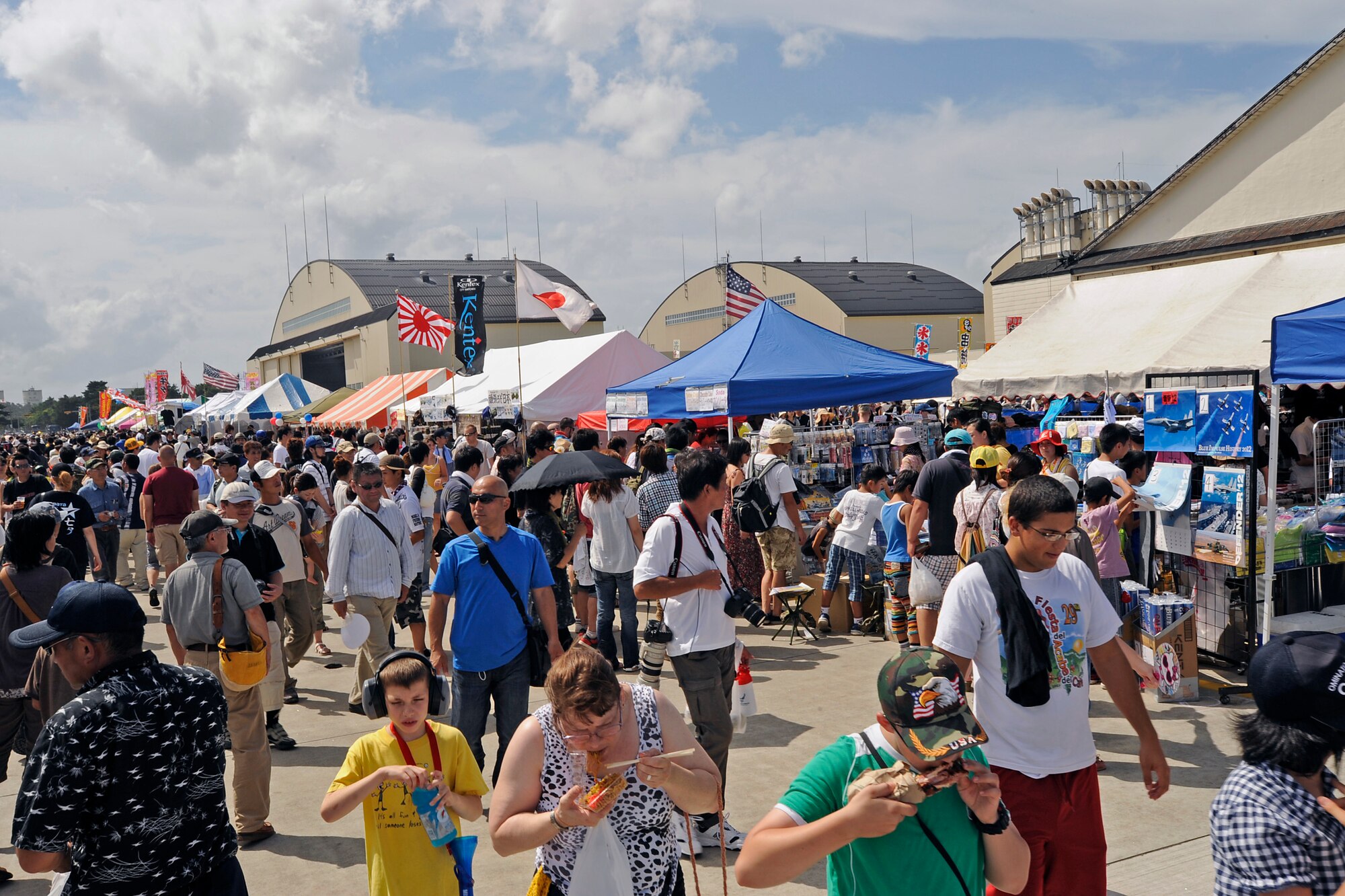 MISAWA AIR BASE, Japan -- Air Fest 2011 attendees explore flight line activities here Sept 4. The Japan Air Self-Defense Force (JASDF) and the 35th Fighter Wing, with associated tenant units, hosted more than 100,000 attendees at Misawa's annual air fest Sept. 4. Air Fest 2011 was an opportunity for visitors to see eight aerial demonstrations with 19 static displays of JASDF, U.S. Air Force, U.S. Navy aircraft and private operators. Air Fest 2011 also marked the last flight of Miss Veedol, a single engine aircraft that in 1931 flew non-stop across the Pacific Ocean from Sabishiro Beach, Misawa, Japan to Wenatchee, Washington U.S. (U.S. Air Force photo by Master Sgt. Maria J. Bare)