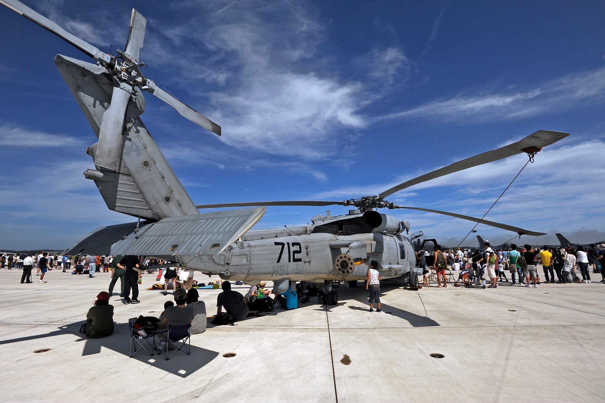 MISAWA AIR BASE, Japan -- Attendees at the Misawa 32nd Annual Misawa air fest escape the sun under a U.S. Navy 60-B Seahawk helicopter from Atsugi Japan here Sept. 4. The Japan Air Self-Defense Force (JASDF) and the 35th Fighter Wing, with associated tenant units, hosted more than 100,000 attendees at the air fest. Air Fest 2011 was an opportunity for visitors to see eight aerial demonstrations with 19 static displays of JASDF, U.S. Air Force, U.S. Navy aircraft and private operators. Air Fest 2011 also marked the last flight of Miss Veedol, a single engine aircraft that in 1931 flew non-stop across the Pacific Ocean from Sabishiro Beach, Misawa, Japan to Wenatchee, Washington, U.S. (U.S. Air Force photo by Master Sgt. Maria J. Bare)