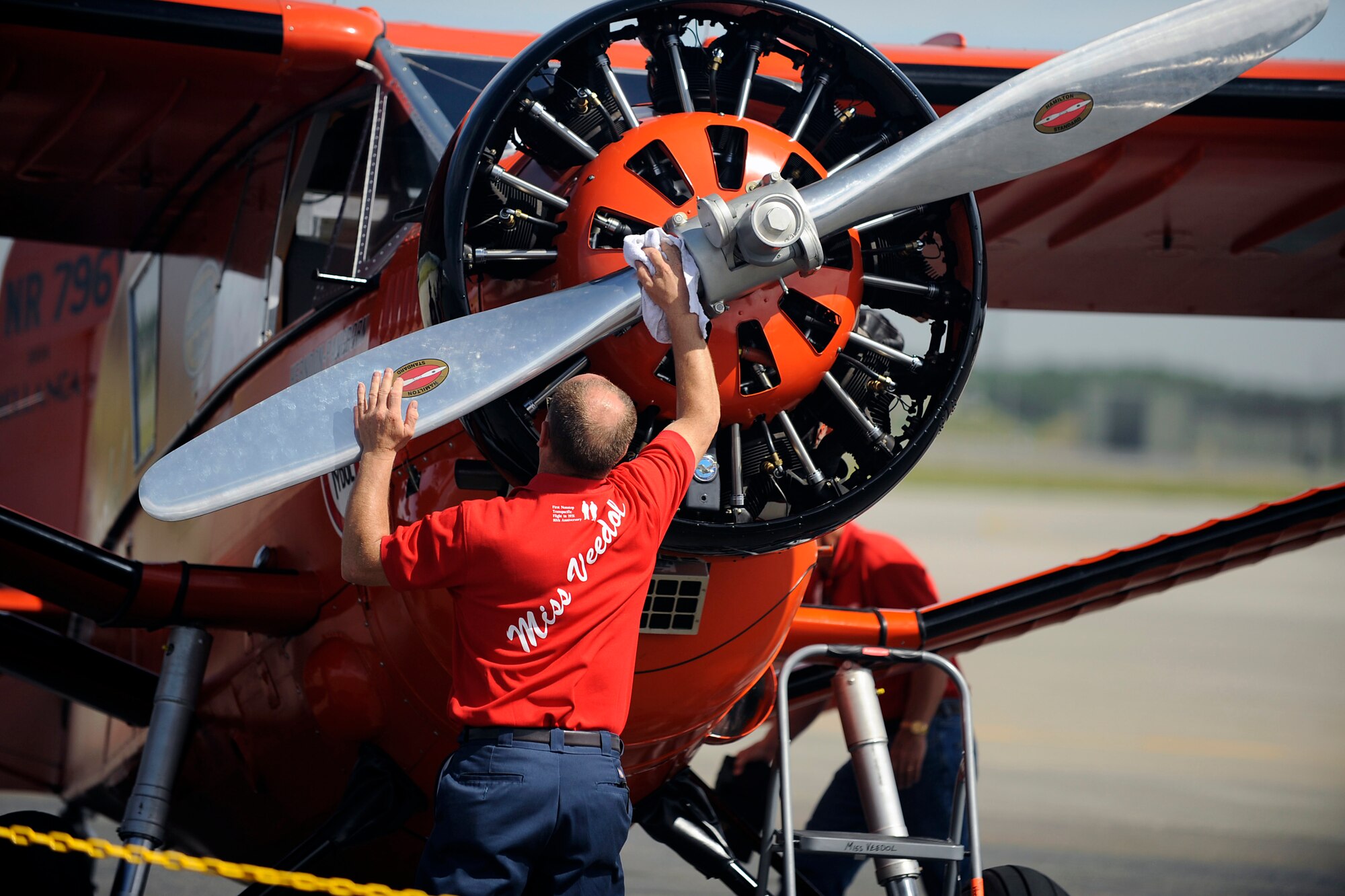 MISAWA AIR BASE, Japan -- A Miss Veedol aviator cleans the propeller after the 9:00 a.m. flyby here Sept 4. The Miss Veedol was the first airplane to fly non-stop across the Pacific Ocean on October 5, 1931. The Japan Air Self-Defense Force (JASDF) and the 35th Fighter Wing, with associated tenant units, hosted more than 100,000 attendees at Misawa's 32nd Annual air fest. Air Fest 2011 was an opportunity for visitors to see eight aerial demonstrations with 19 static displays of JASDF, U.S. Air Force, U.S. Navy aircraft and private operators. Air Fest 2011 also marked the last flight of Miss Veedol, a single engine aircraft that in 1931 flew non-stop across the Pacific Ocean from Sabishiro Beach, Misawa, Japan to Wenatchee, Washington, U.S. (U.S. Air Force photo by Master Sgt. Maria J. Bare)