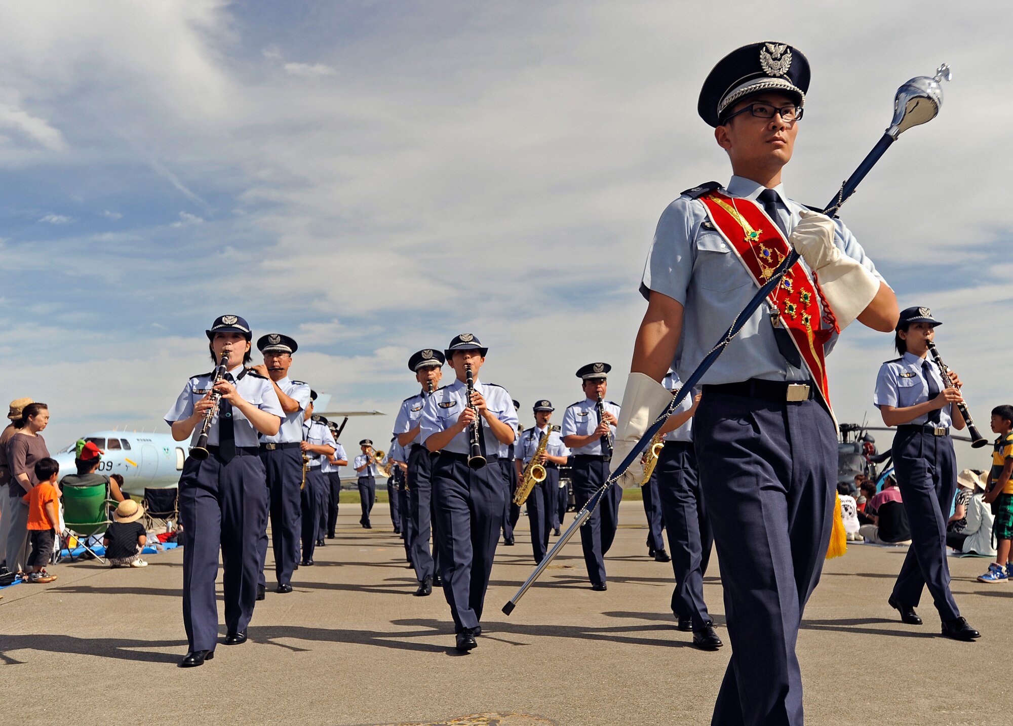 MISAWA AIR BASE, Japan -- The Misawa Japanese Air Self-Defense Force (JASDF) marching band pass spectators at the 32nd Annual Miawa Air Fest here, Sept. 4. The Japan Air Self-Defense Force and the 35th Fighter Wing, with associated tenant units, hosted more than 100,000 attendees. Air Fest 2011 was an opportunity for visitors to see eight aerial demonstrations with 19 static displays of JASDF, U.S. Air Force, U.S. Navy aircraft and private operators. Air Fest 2011 also marked the last flight of Miss Veedol, a single engine aircraft that in 1931 flew non-stop across the Pacific Ocean from Sabishiro Beach, Misawa, Japan to Wenatchee, Washington, U.S. (U.S. Air Force photo by Master Sgt. Maria J. Bare)